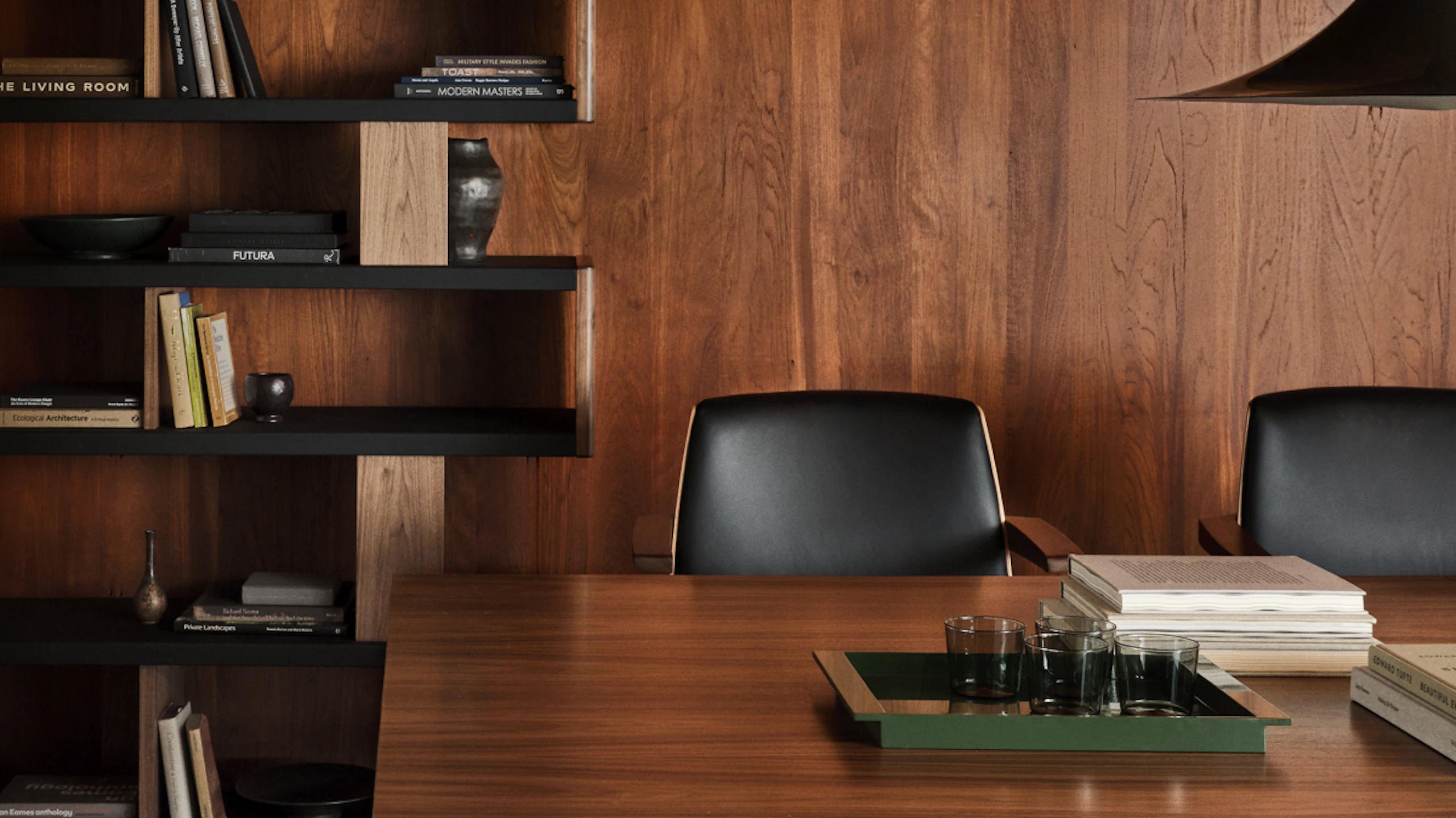 MP Conference Table designed by Amir Paknya for Geiger in Natural Flat Cut Walnut shown with low-back Clamshell Chairs and a New Canaan Bookshelf.