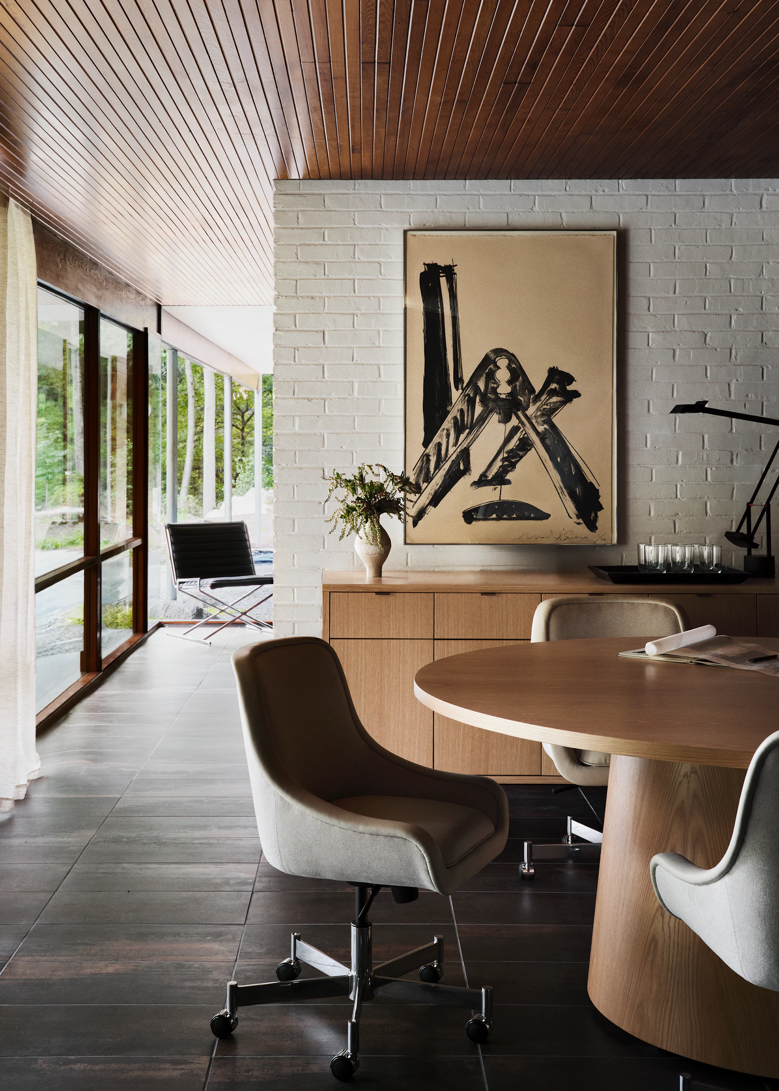 JD Meeting Table in natural flat cut oak shown surrounded by Bumper Chairs in front of a Highline 25 Credenza with a Sled Chair in the background.