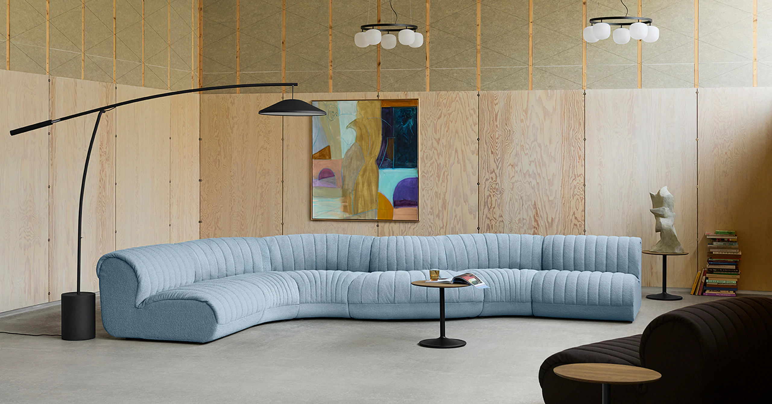 Light blue Coltre Sofa from Muuto in a large, well-decorated space.