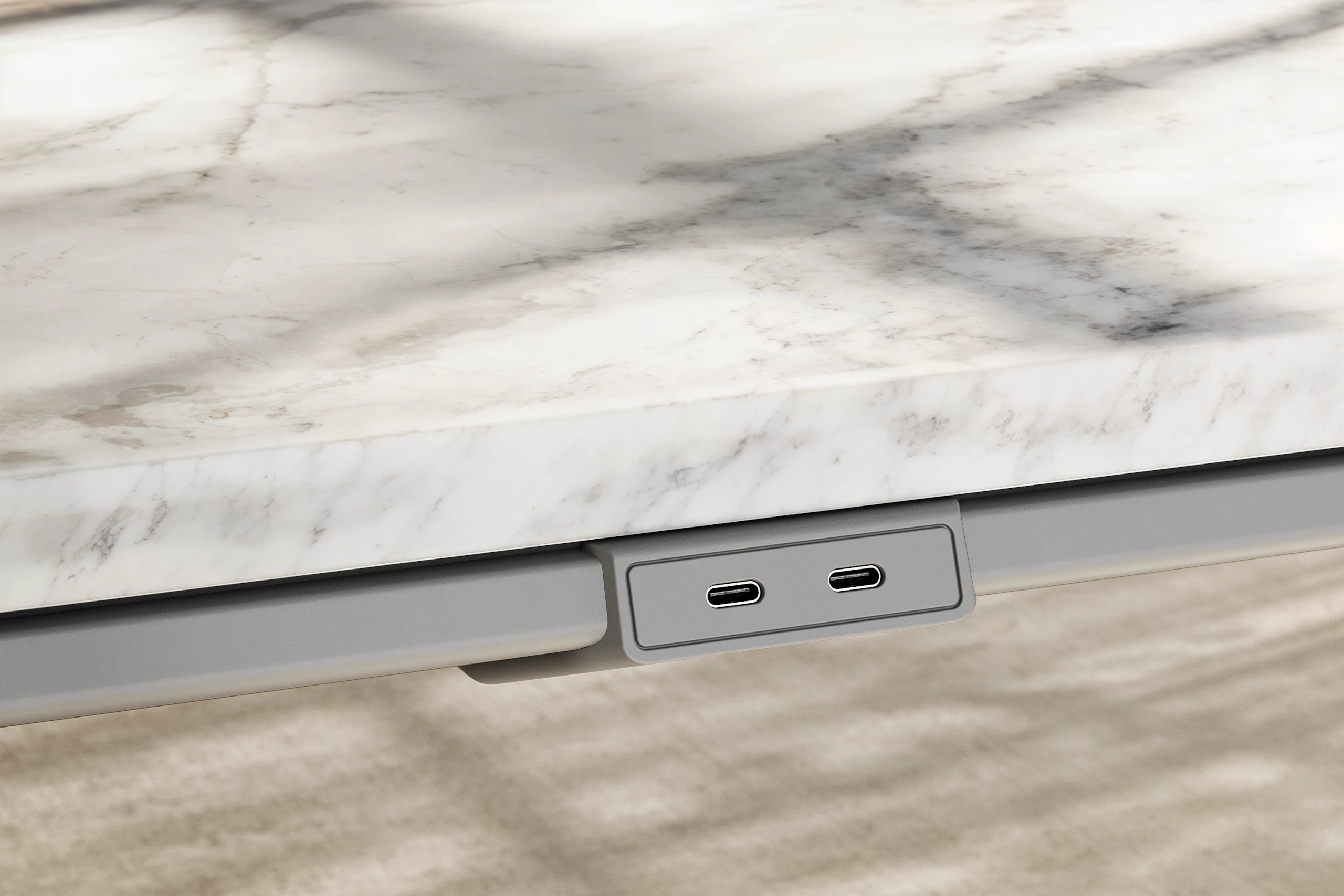 Detail of Ascent Conference Table by EOOS in White Carrara marble showing edge with power access in medium grey viewed at an angle.