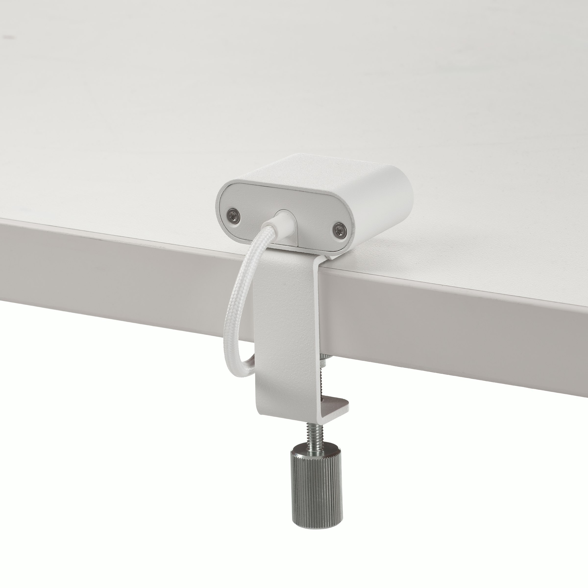 White USB-C power access module that is attached to a white surface.