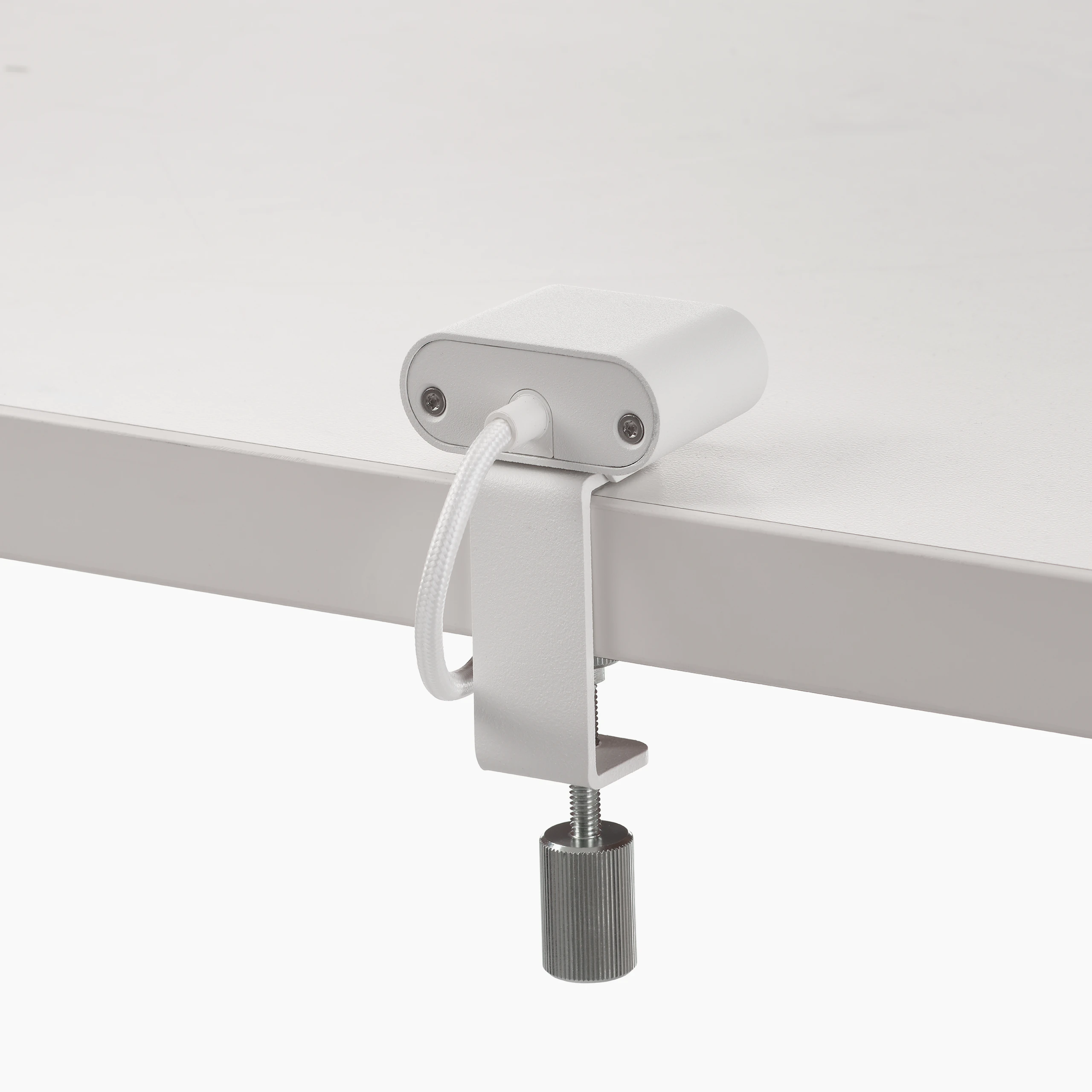 White USB-C power access module that is attached to a white surface.