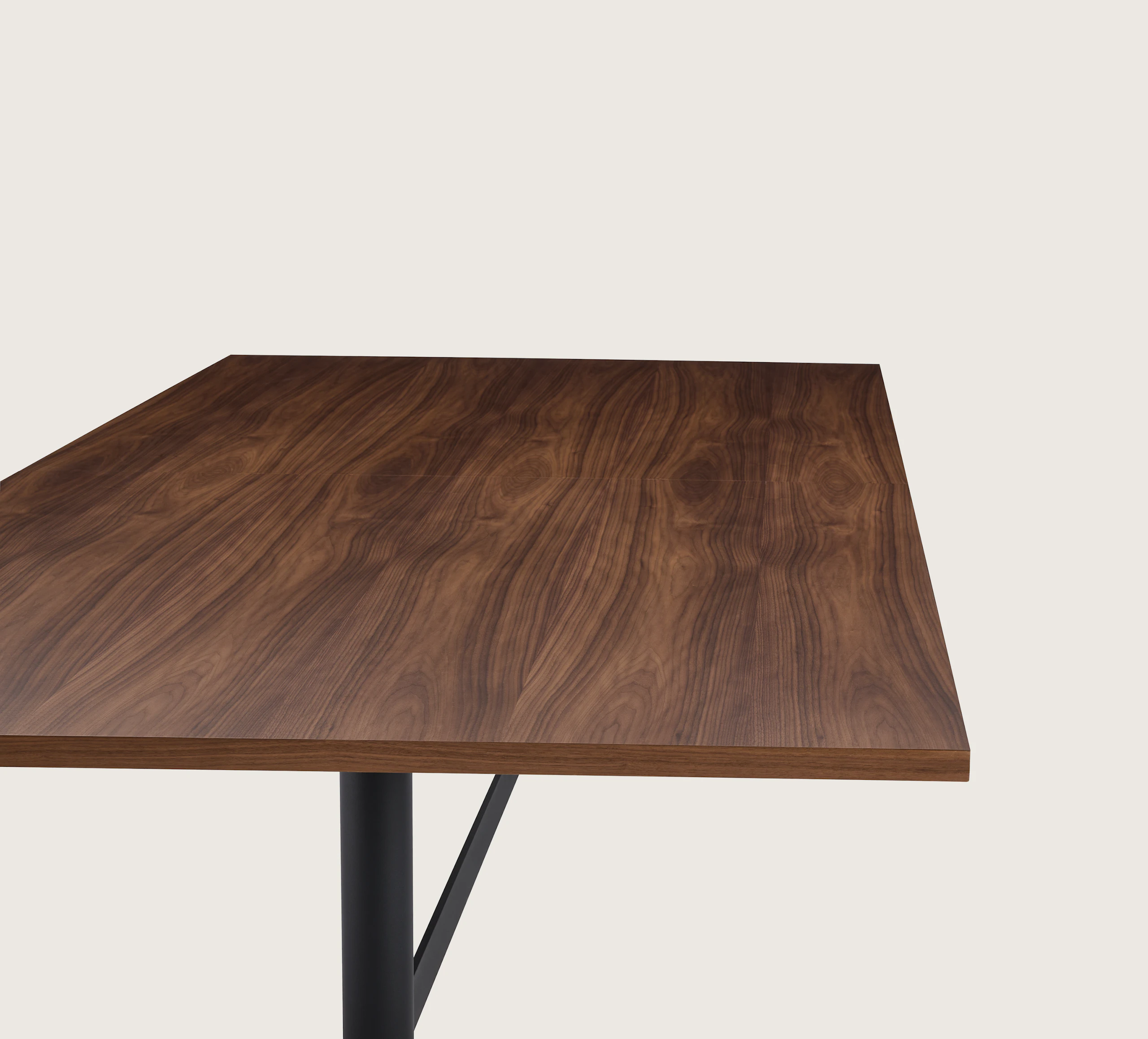 MP Table designed by Amir Paknya for Geiger in Natural Flat Cut Walnut shown on a white sweep, detail view of table edge.