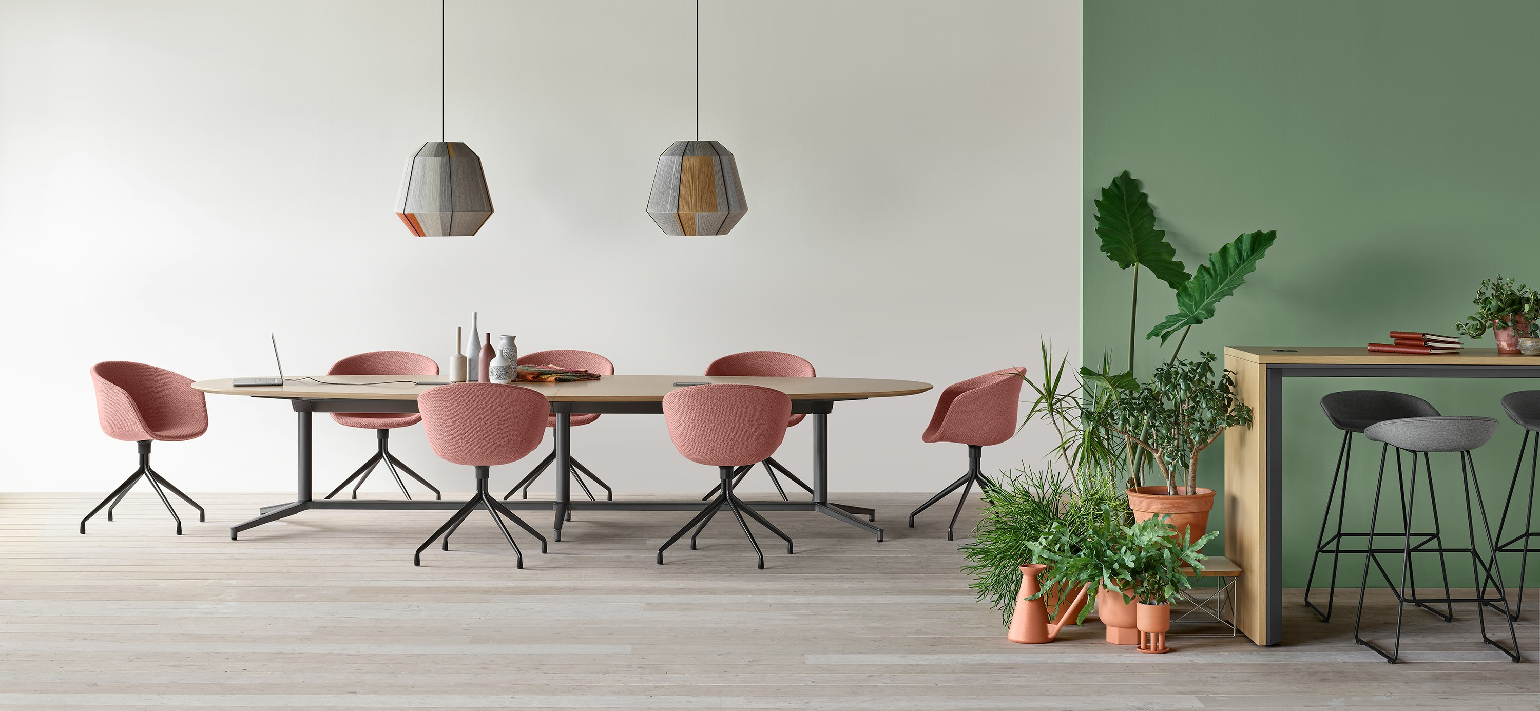 A Y base Headway conference table surrounded by seven About a Chairs in an open conference space.