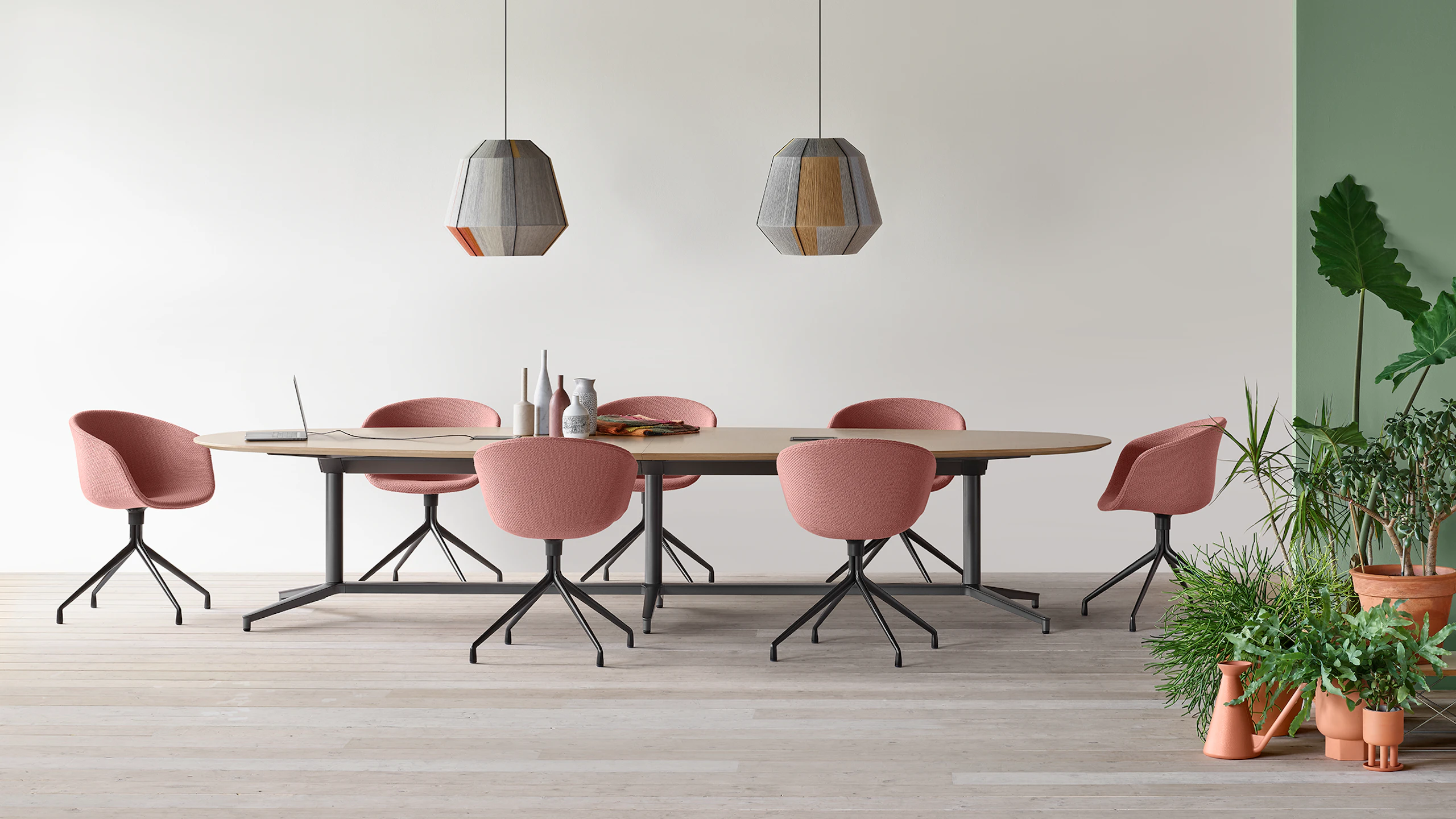 A Y base Headway conference table surrounded by seven About a Chairs in an open conference space.