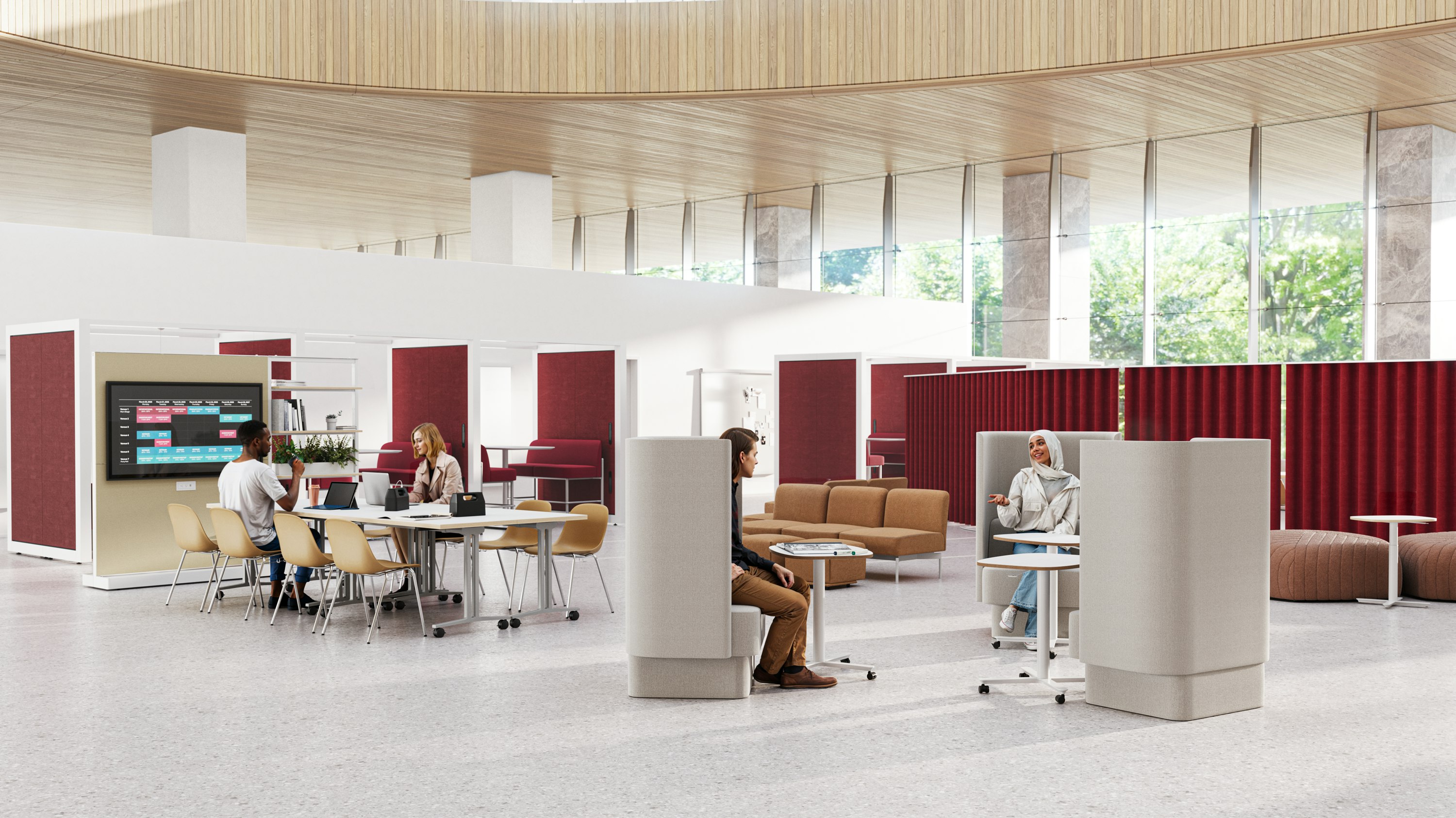Communal working area with people working in Pullman Chairs and at Passport Tables. 