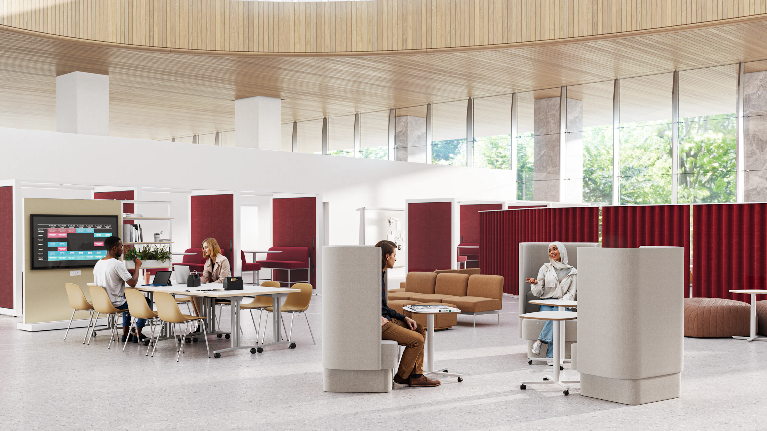 Communal working area with people working in Pullman Chairs and at Passport Tables.