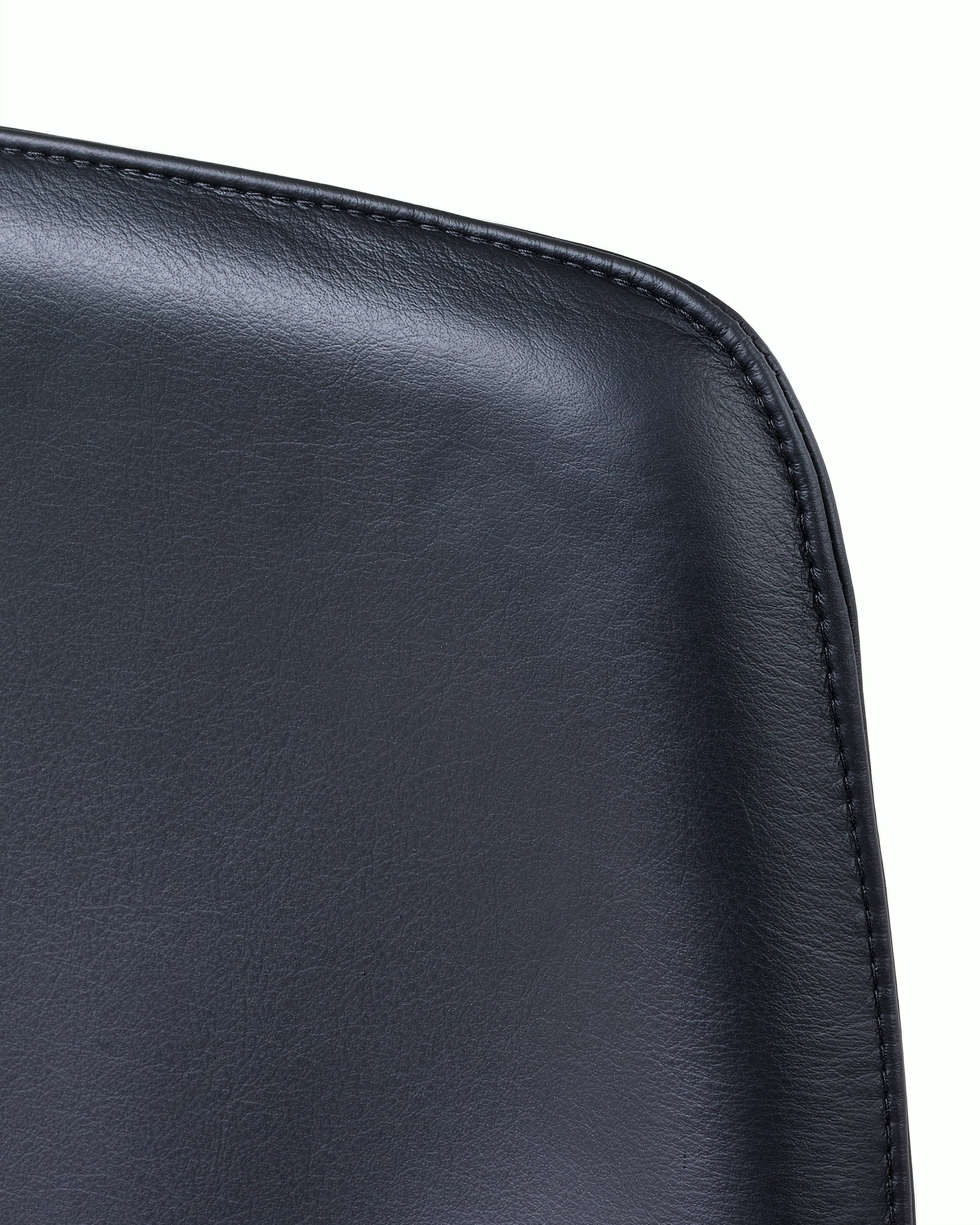 Close-up of an upper corner on the back of a Taper office chair, showing the lapped-edge stitch option.