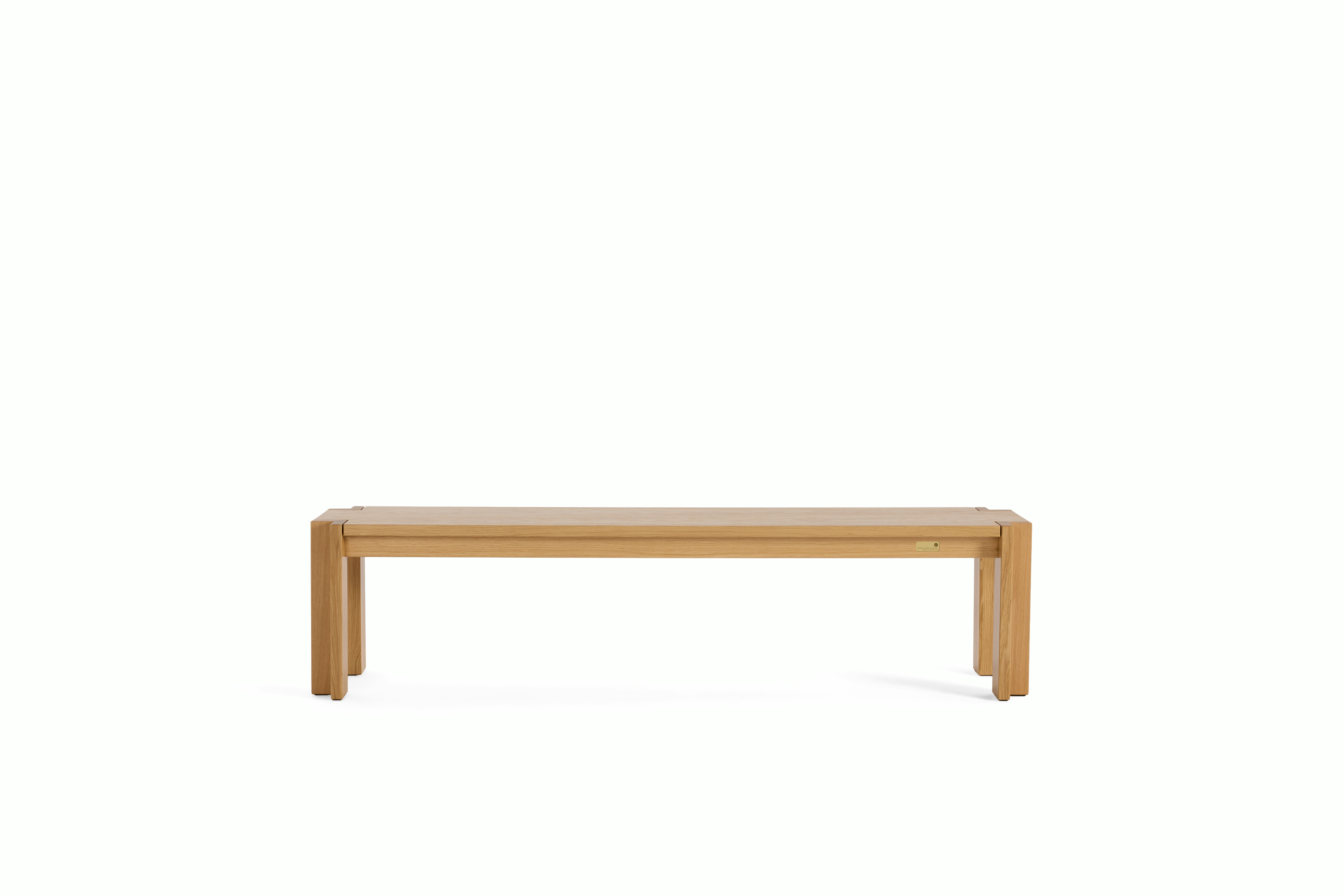 A Utzon Dining Bench in Oak viewed from the front.