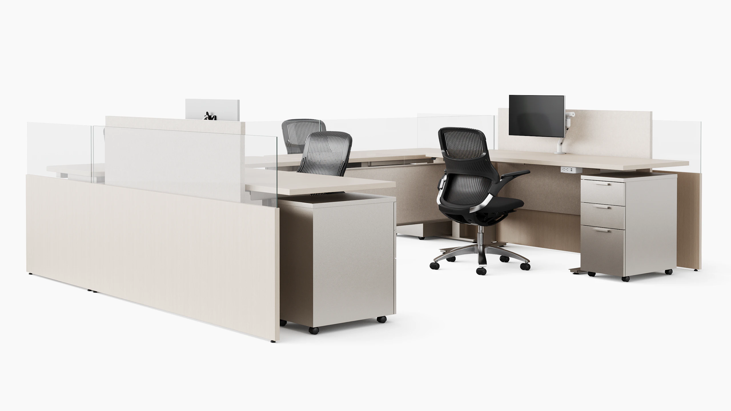 A group of light colored open office workstations are shown at an angle.