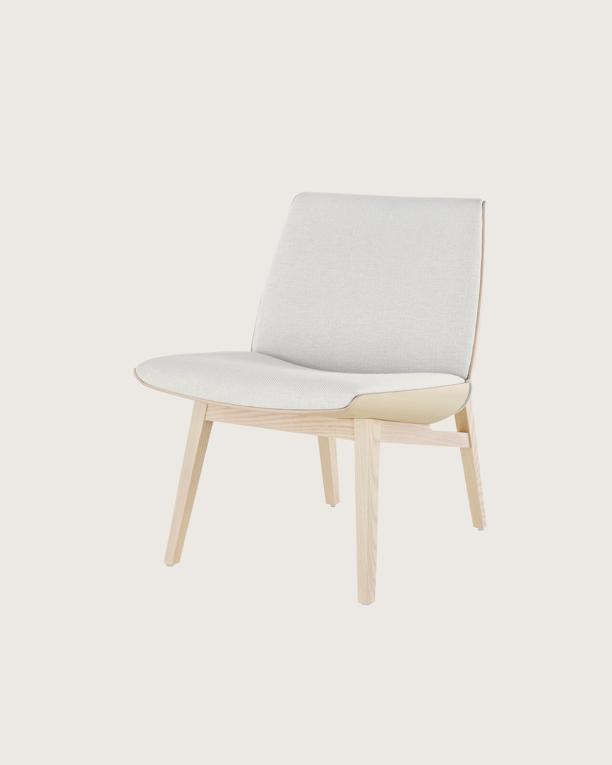 Angled view of a low-back Clamshell Lounge Chair with off-white fabric upholstery and light-ash legs.