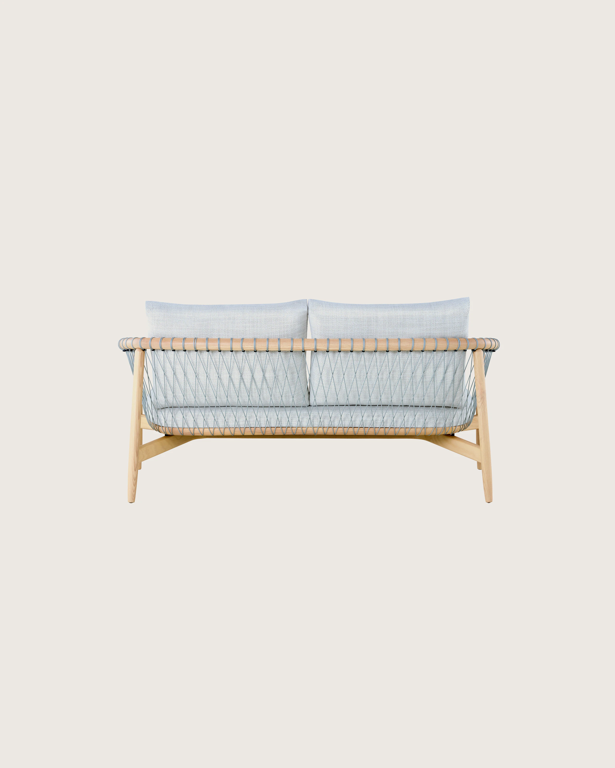 A light-colored Crosshatch Settee featuring gray upholstery and a white ash frame. Viewed from behind.