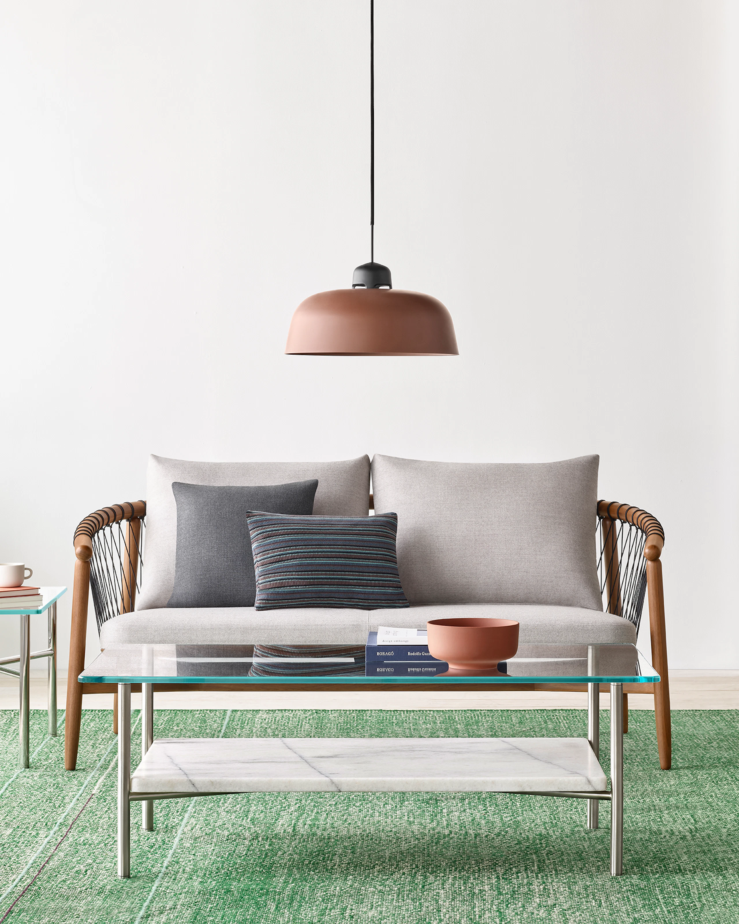 A casual lounge setting with a Layer Table anchoring a Crosshatch Settee and Crosshatch Chair.