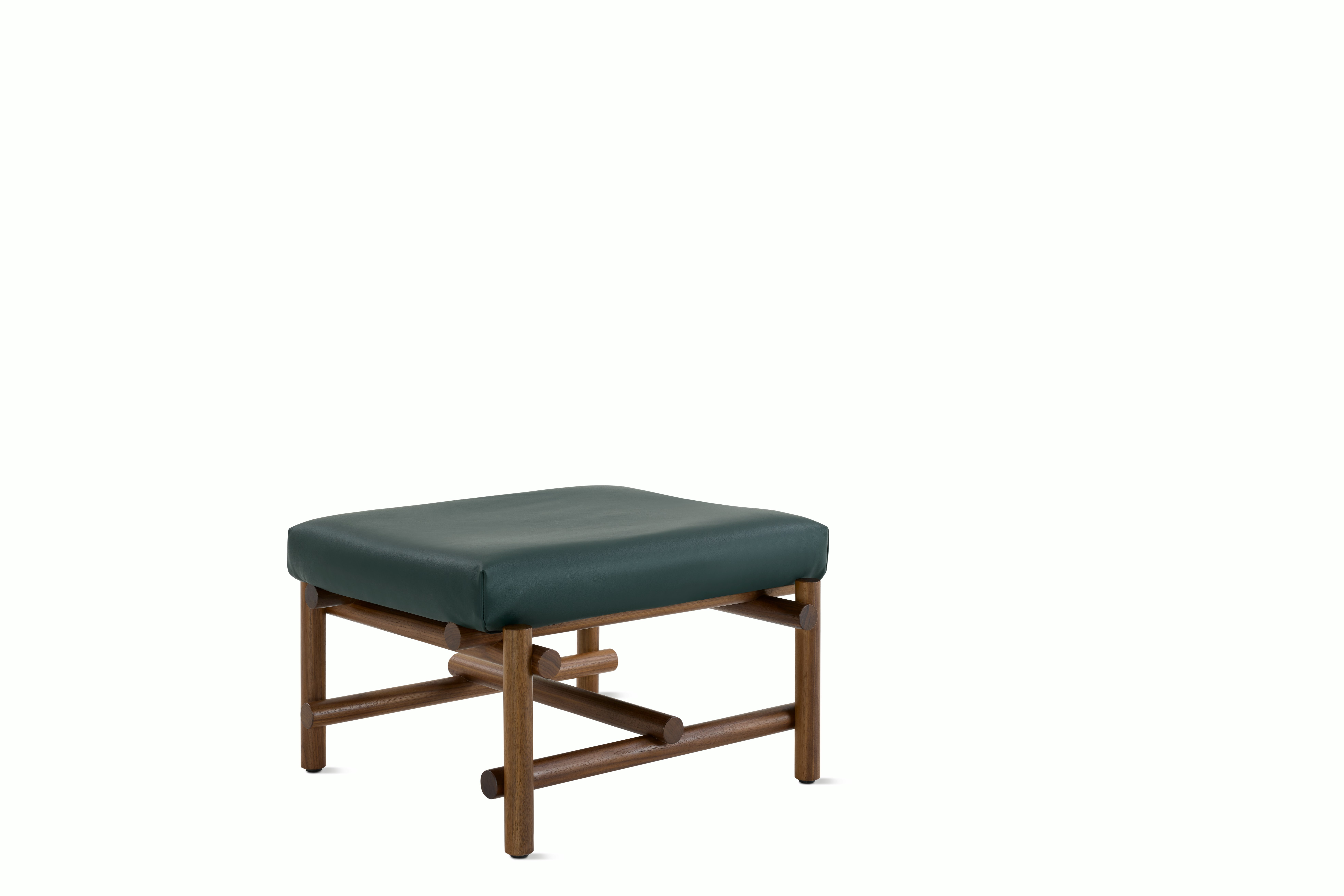 A Muecke Ottoman in Forest Green Walnut viewed from an angle.