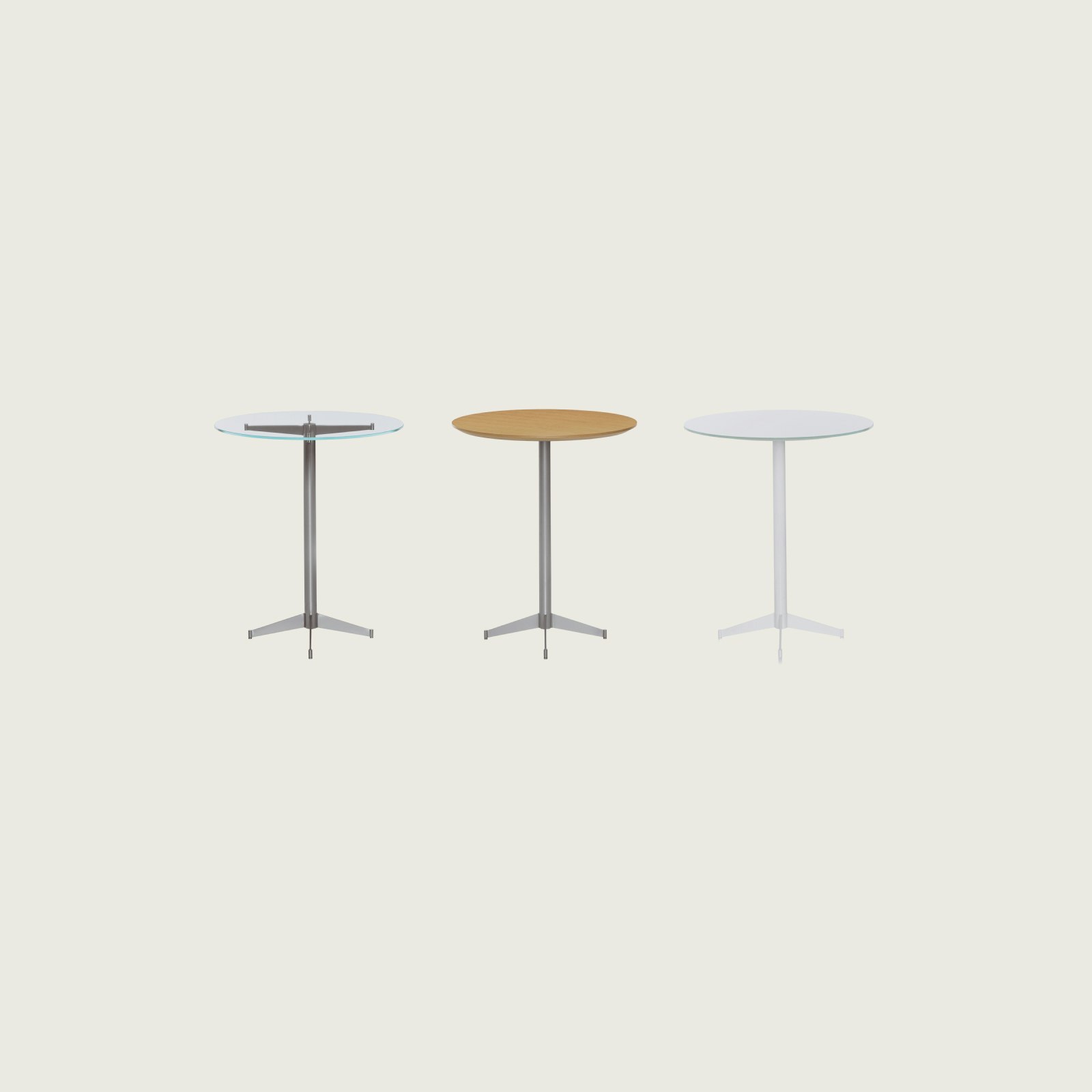 Three round MP Tables lined up with against a white background. Each table has a different finish. Back-painted glass and wood top.