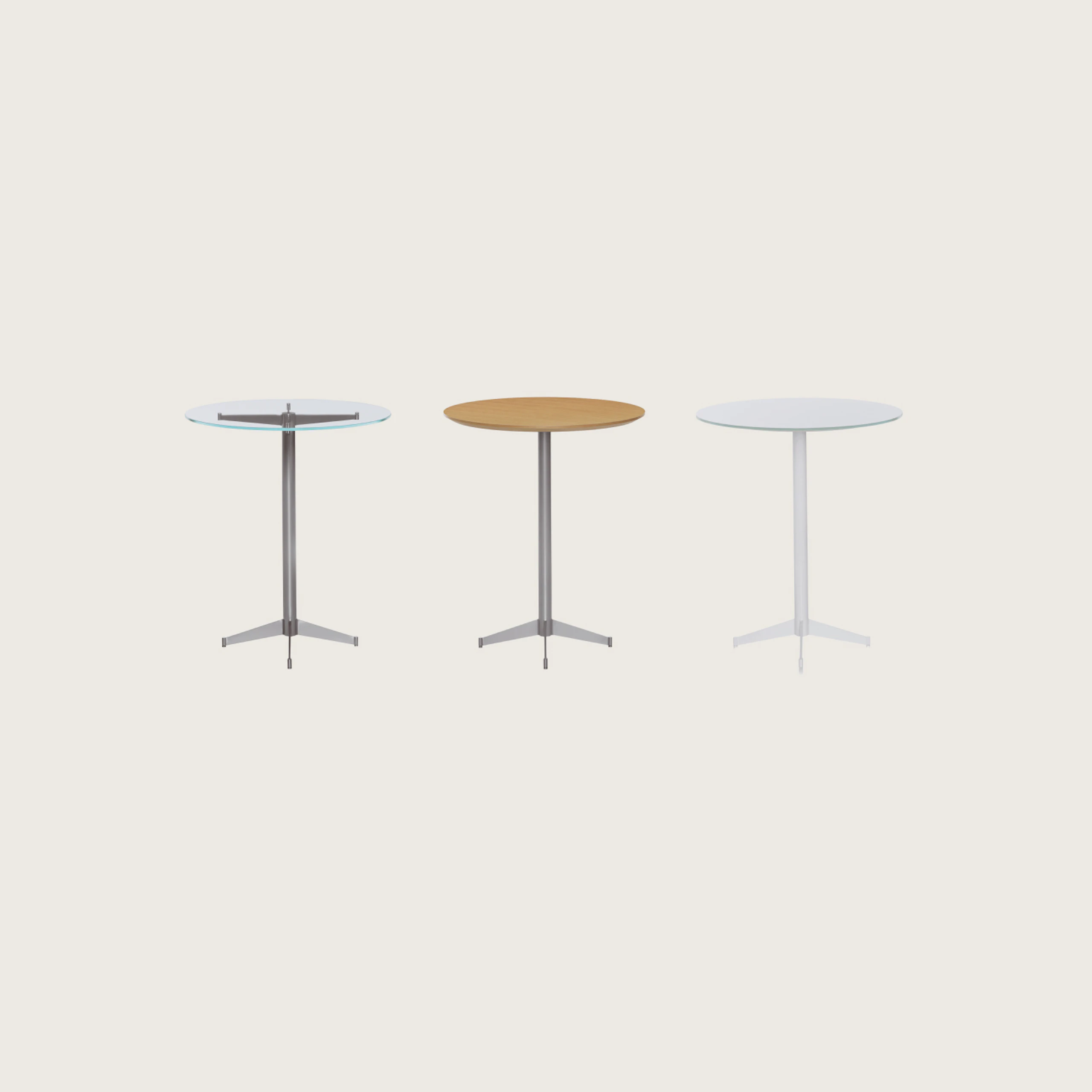 Three round MP Tables lined up with against a white background. Each table has a different finish. Back-painted glass and wood top.