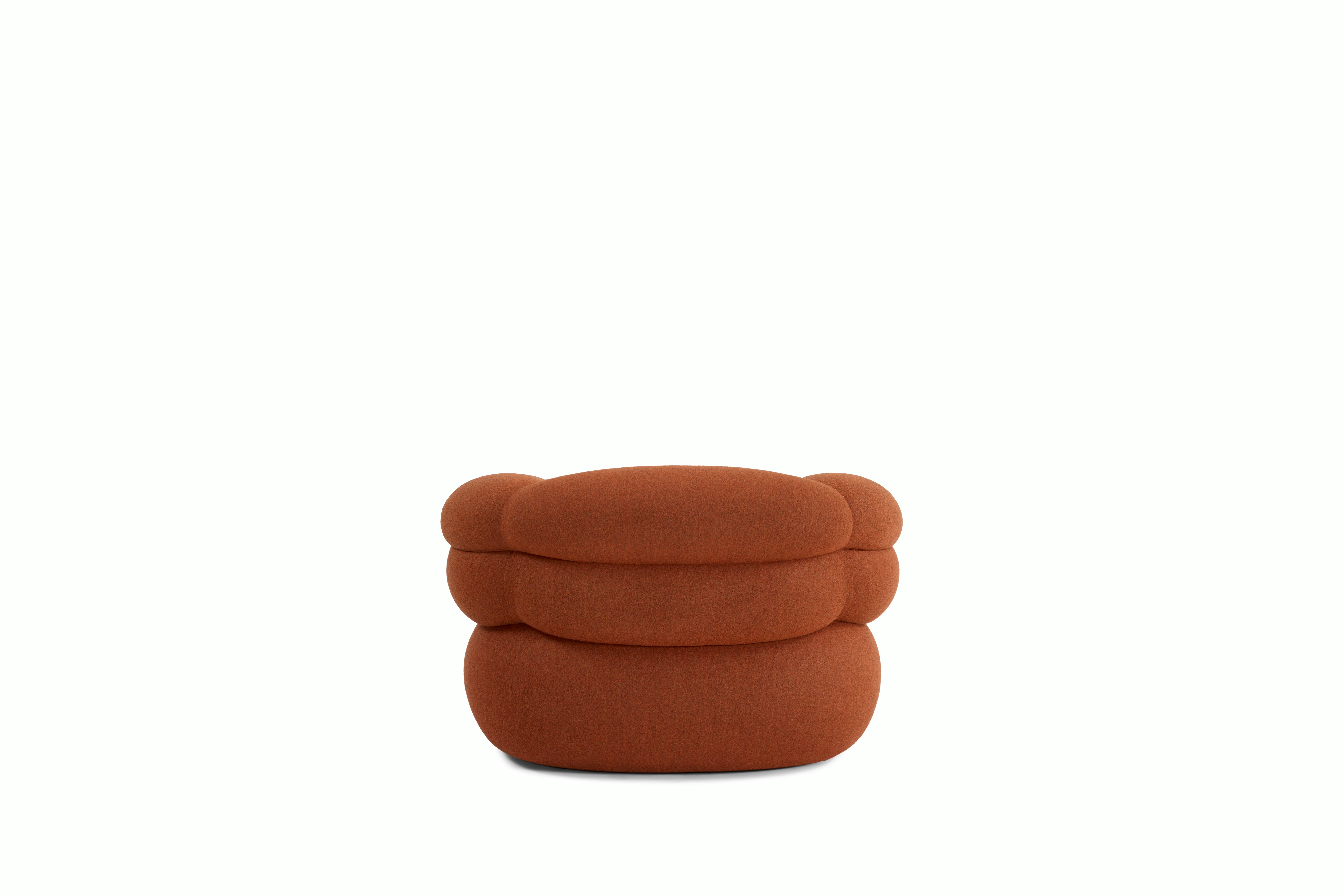 A Biboni Lounge Chair in Stellium, Iron Red viewed from behind.