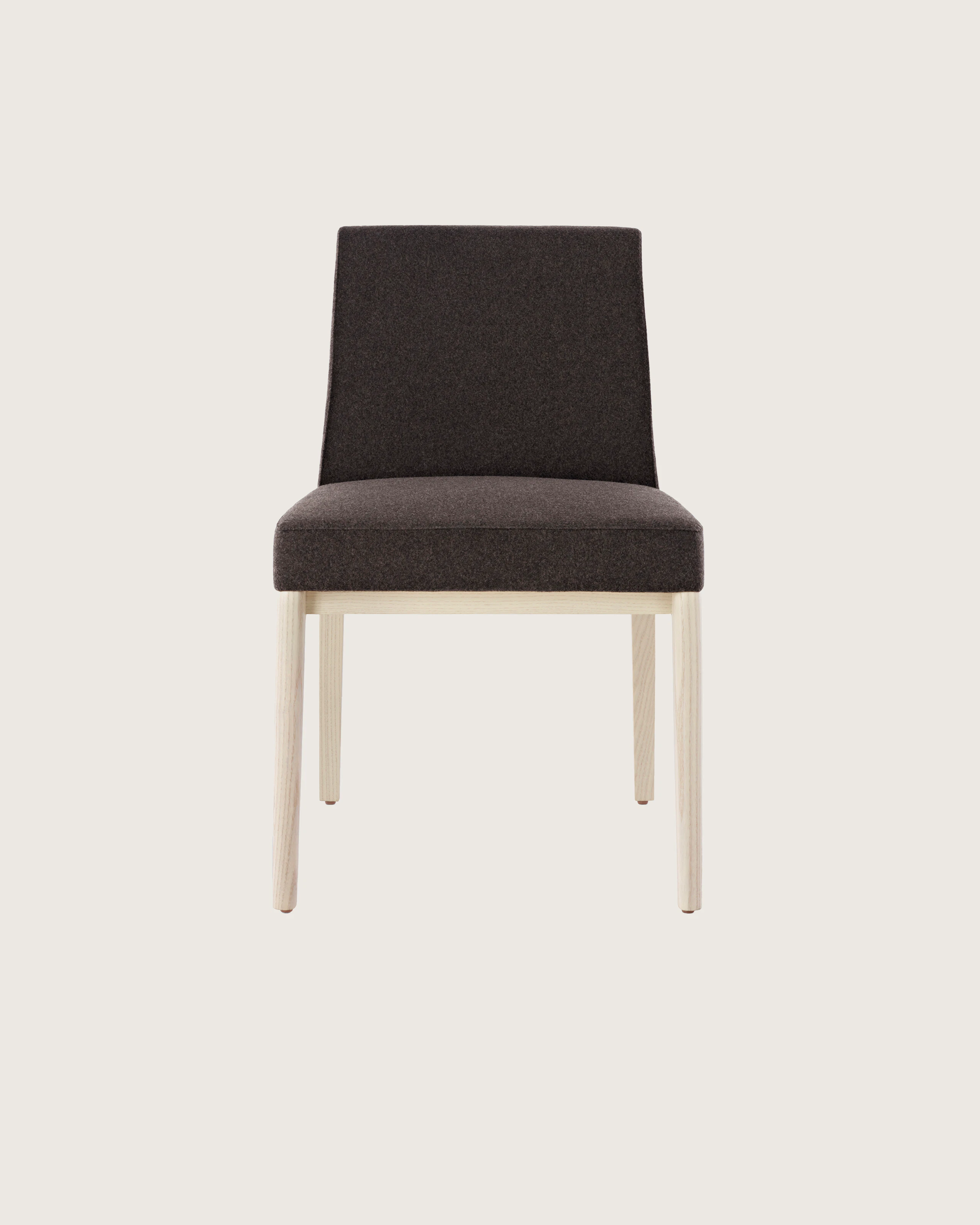 An armless Nessel side chair with black fabric upholstery and a wood frame with a light finish, viewed from the front.