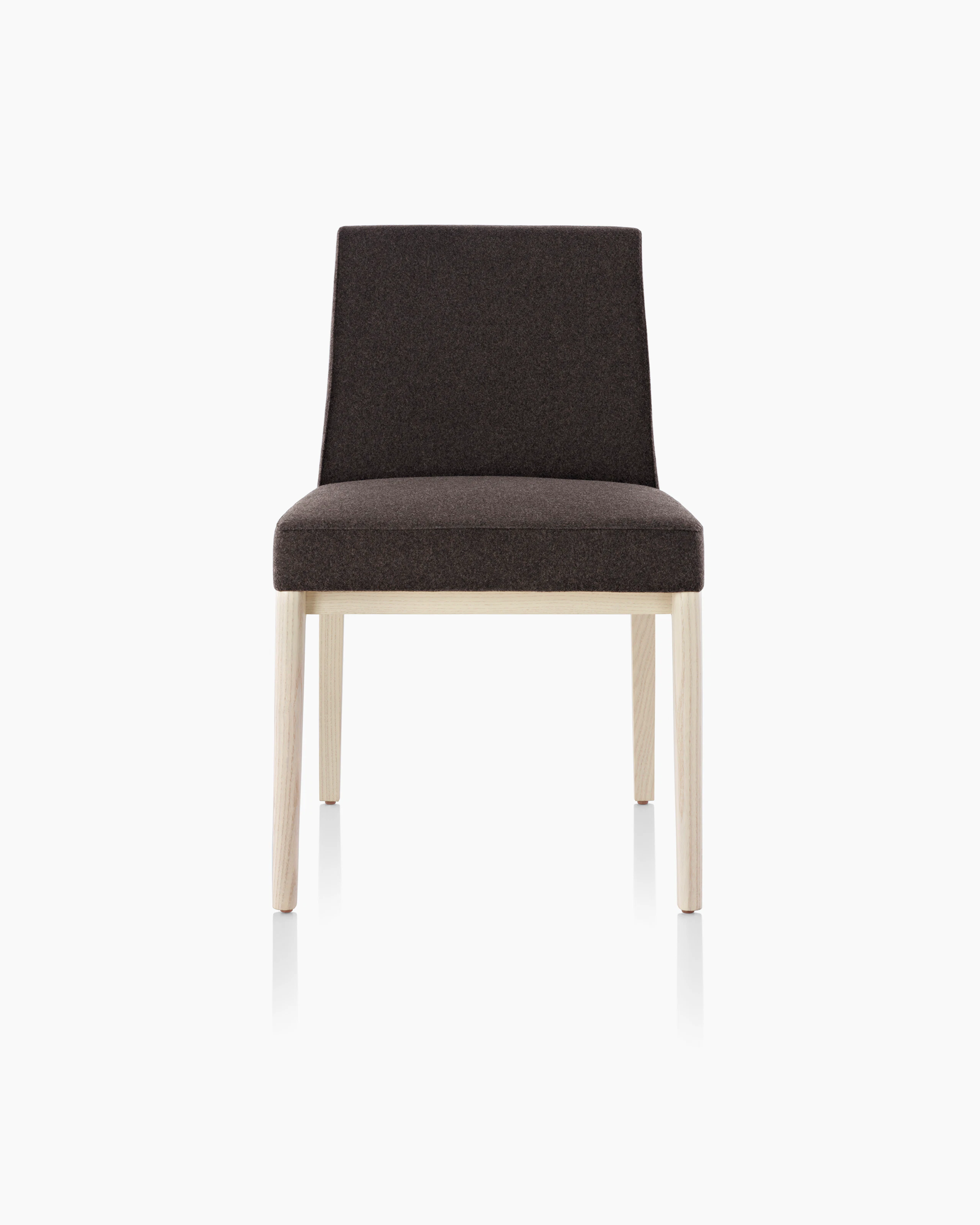 An armless Nessel side chair with black fabric upholstery and a wood frame with a light finish, viewed from the front.