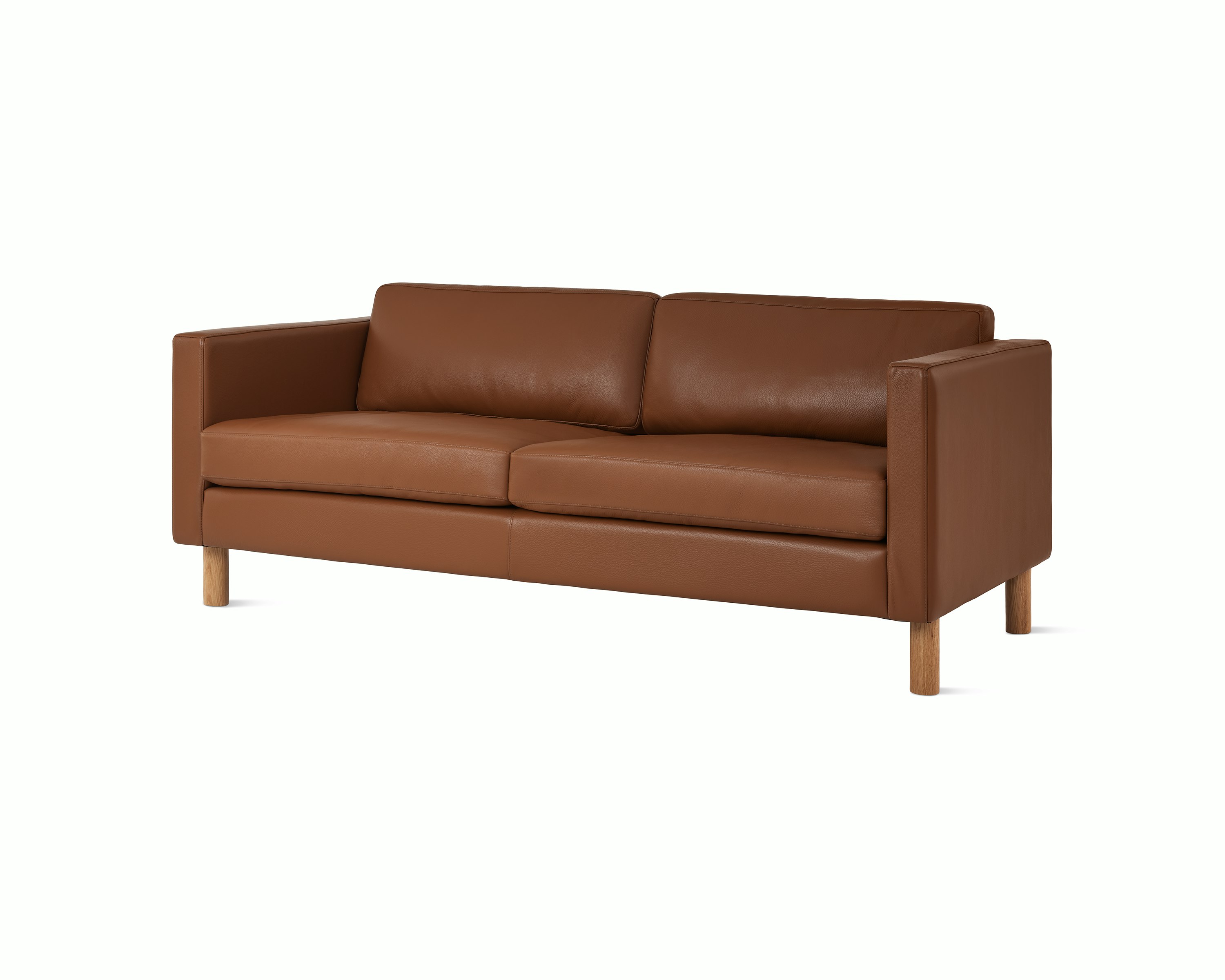Lispenard sofa with brown leather upholstery and walnut legs, viewed from an angle.