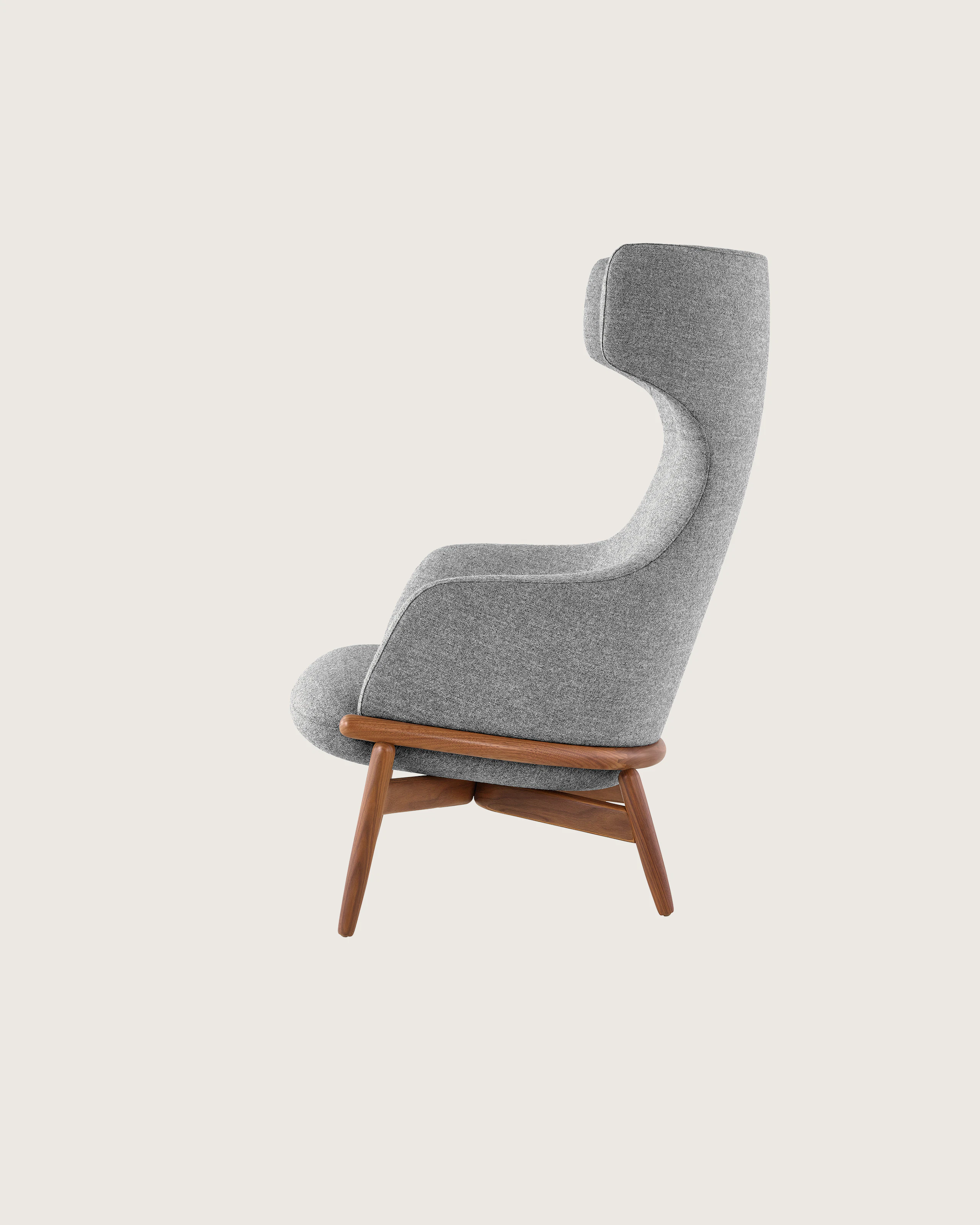 A wing-back Reframe Lounge Chair in Panno Di Dolce Flannel, viewed from the side.