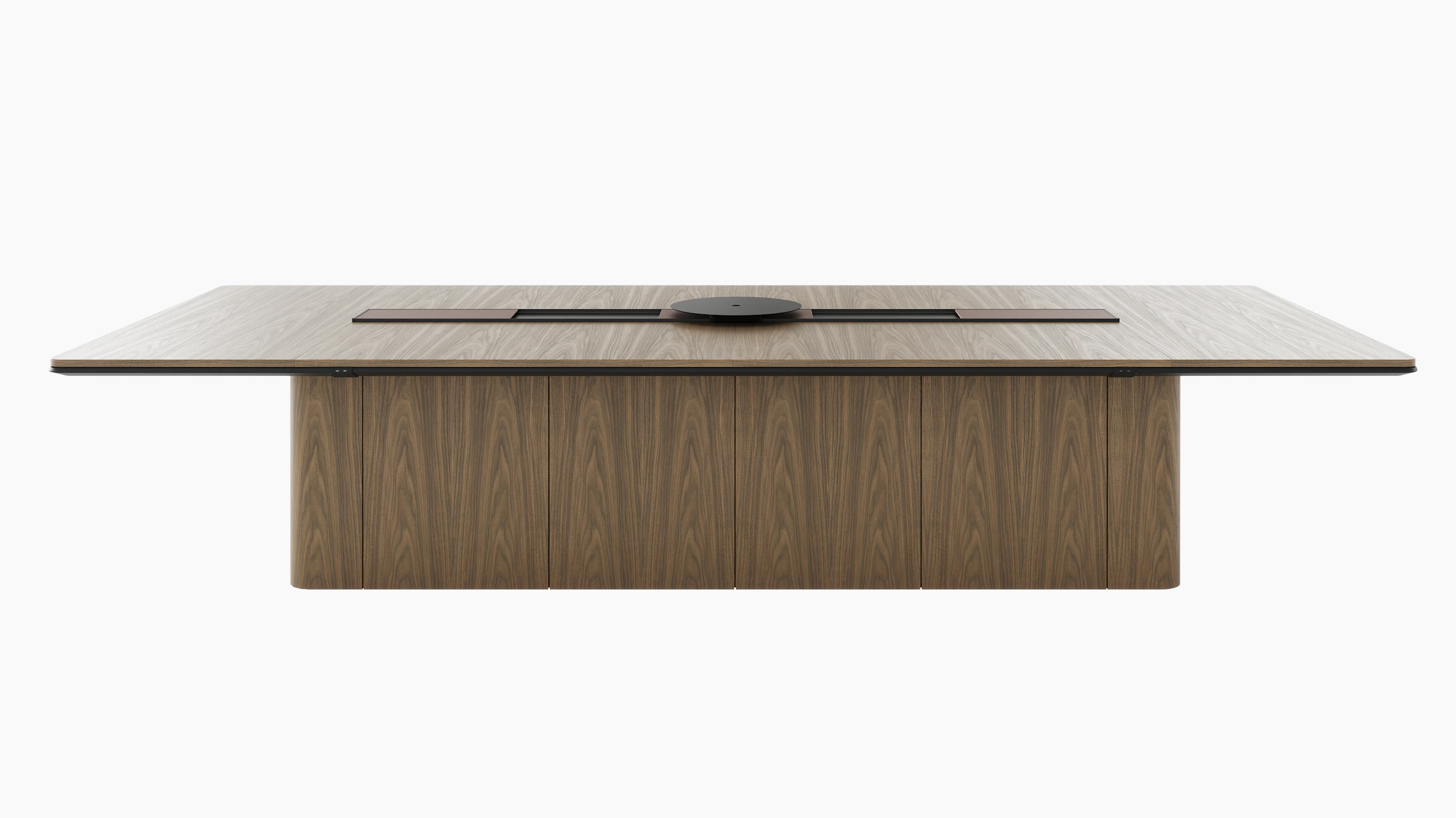 60"x144" Ascent Conference Table designed by EOOS in Natural Flat Cut Walnut with a plinth base, central power trough, an AV platform, and accessory trays, viewed from the front.