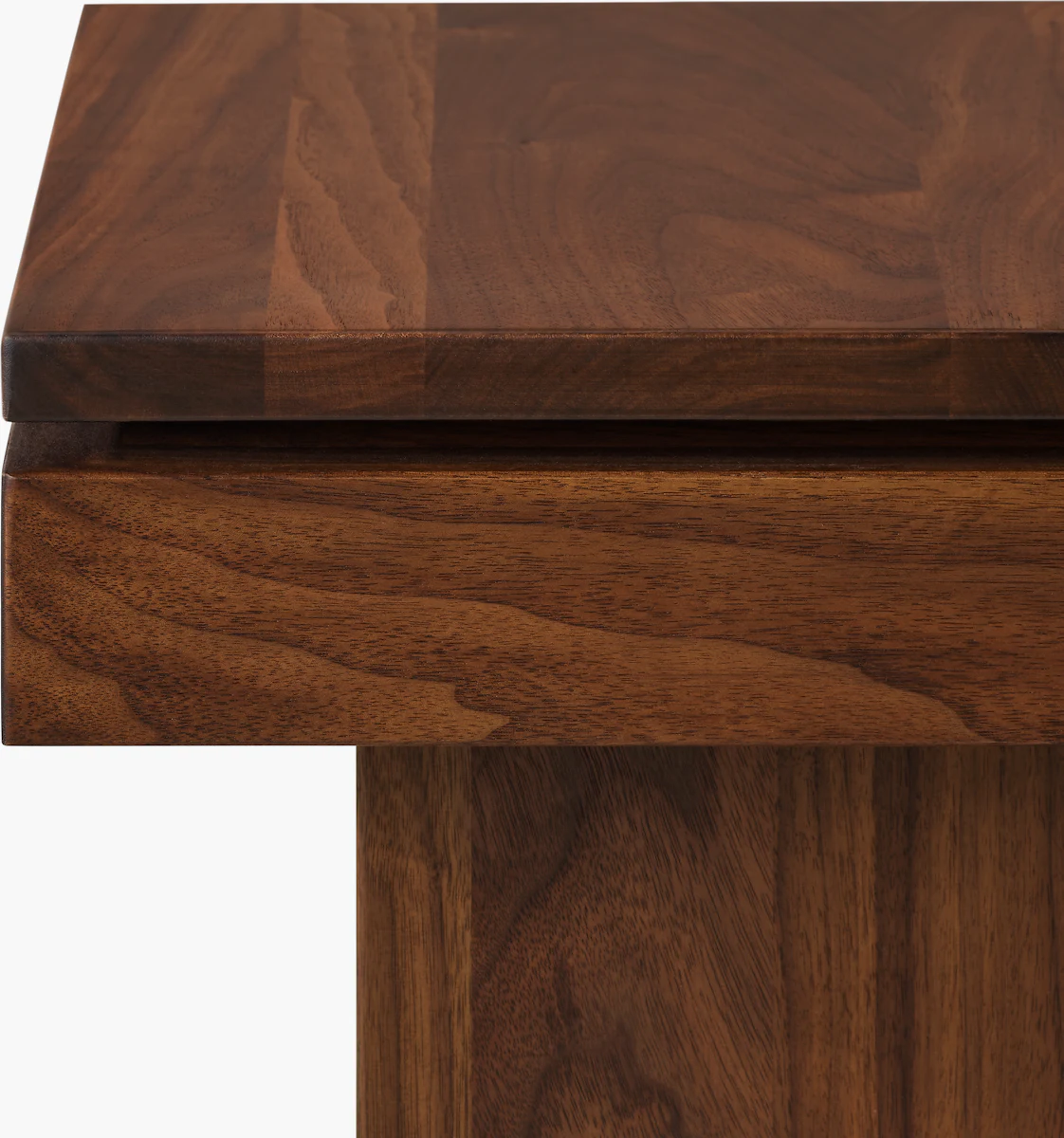 Close-up of wooden edge of a coffee table in Tudor Walnut finish