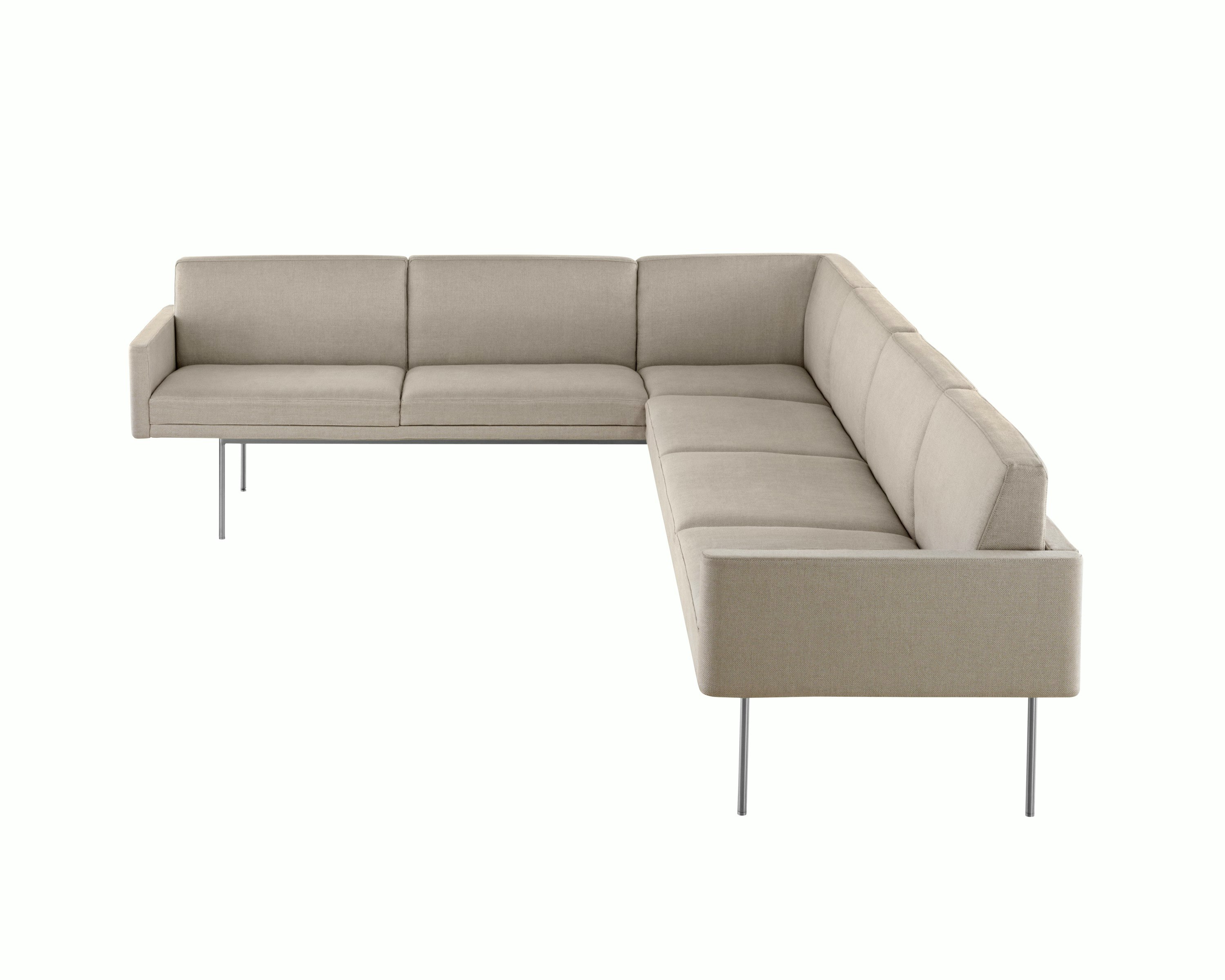Partial view of a non-quilted Tuxedo Component corner unit upholstered in beige fabric.