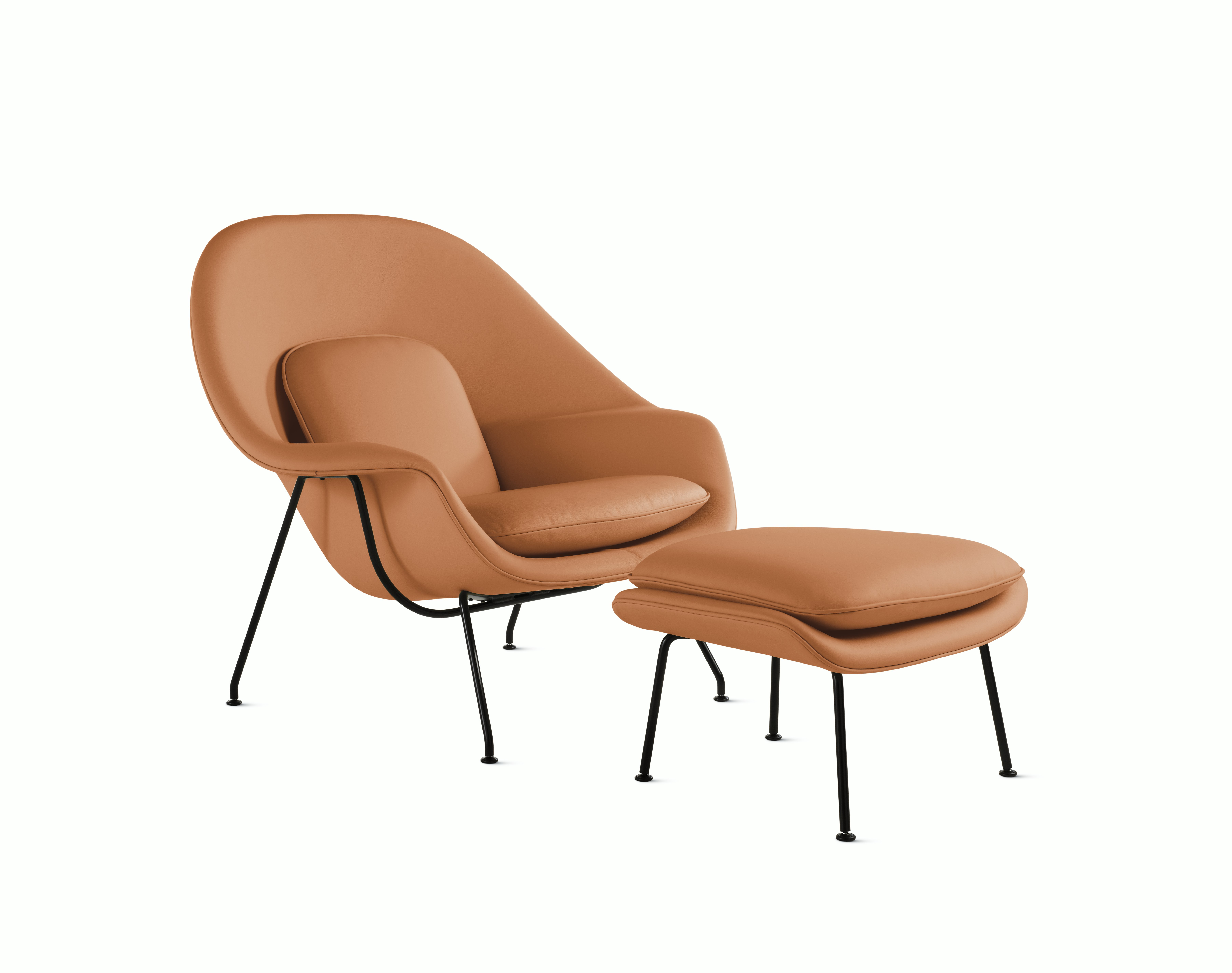 A tobacco Womb Chair & Ottoman viewed from an angle