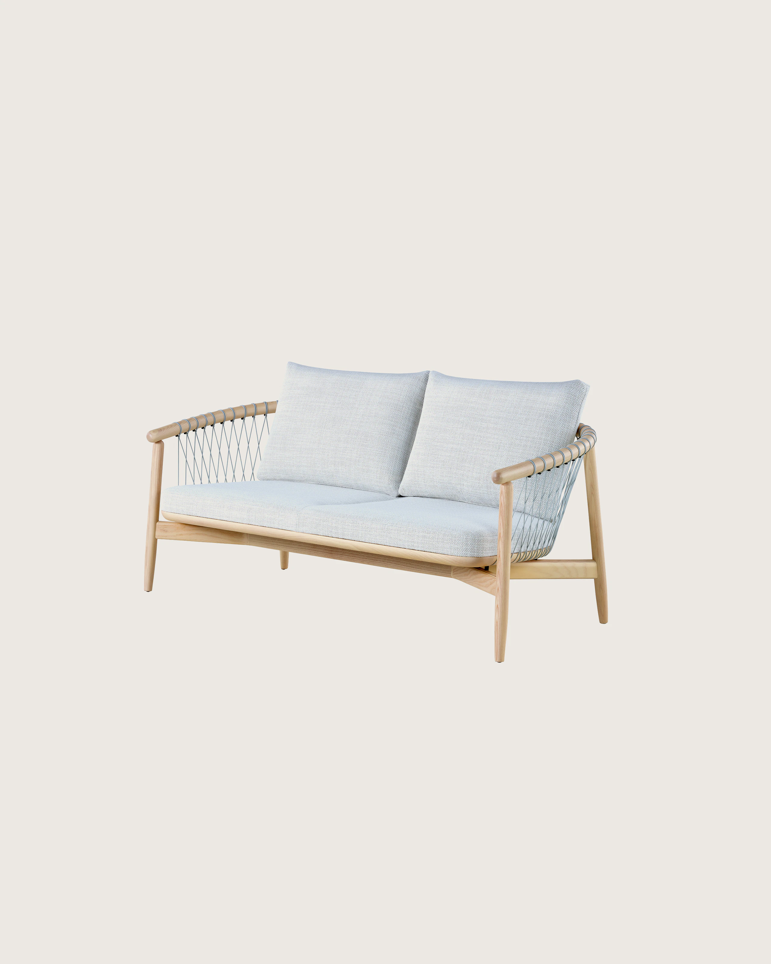A light-colored Crosshatch Settee featuring gray upholstery and a white ash frame. Viewed at an angle.