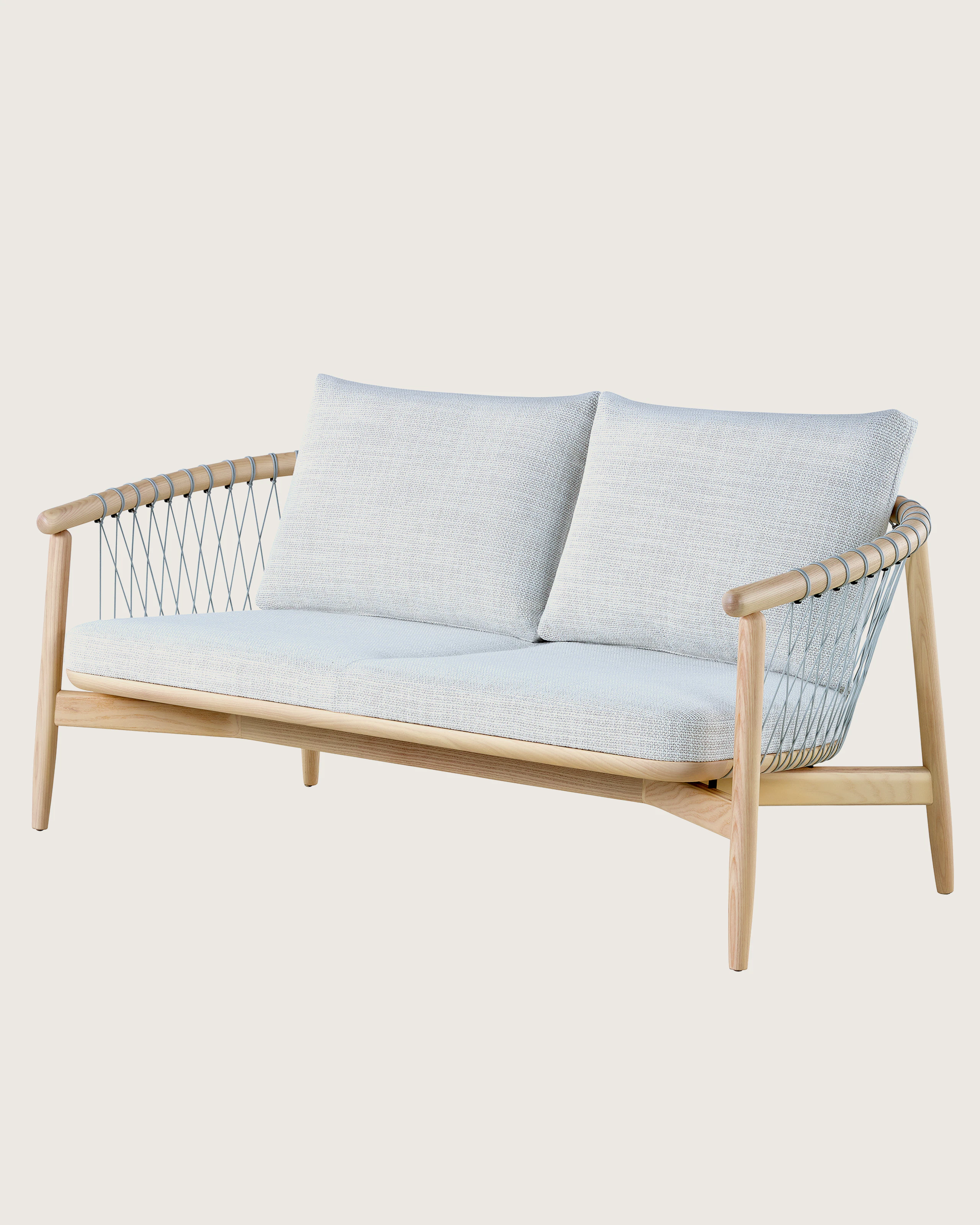 A light-colored Crosshatch Settee featuring gray upholstery and a white ash frame. Viewed at an angle.
