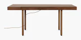 A New Canaan Wood Sit-to-Stand Desk in Walnut viewed from the front. A New Canaan Wood Sit-to-Stand Desk in Walnut viewed from the front.