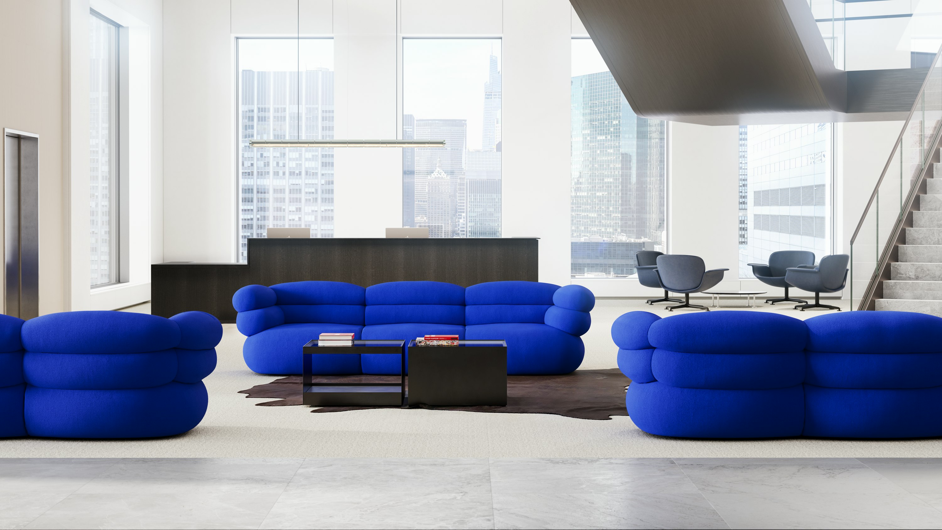 Lobby or reception space with blue Biboni Sofas, black D'Urso Coffee Tables and blue KN01 Lounge Chairs in the background.
