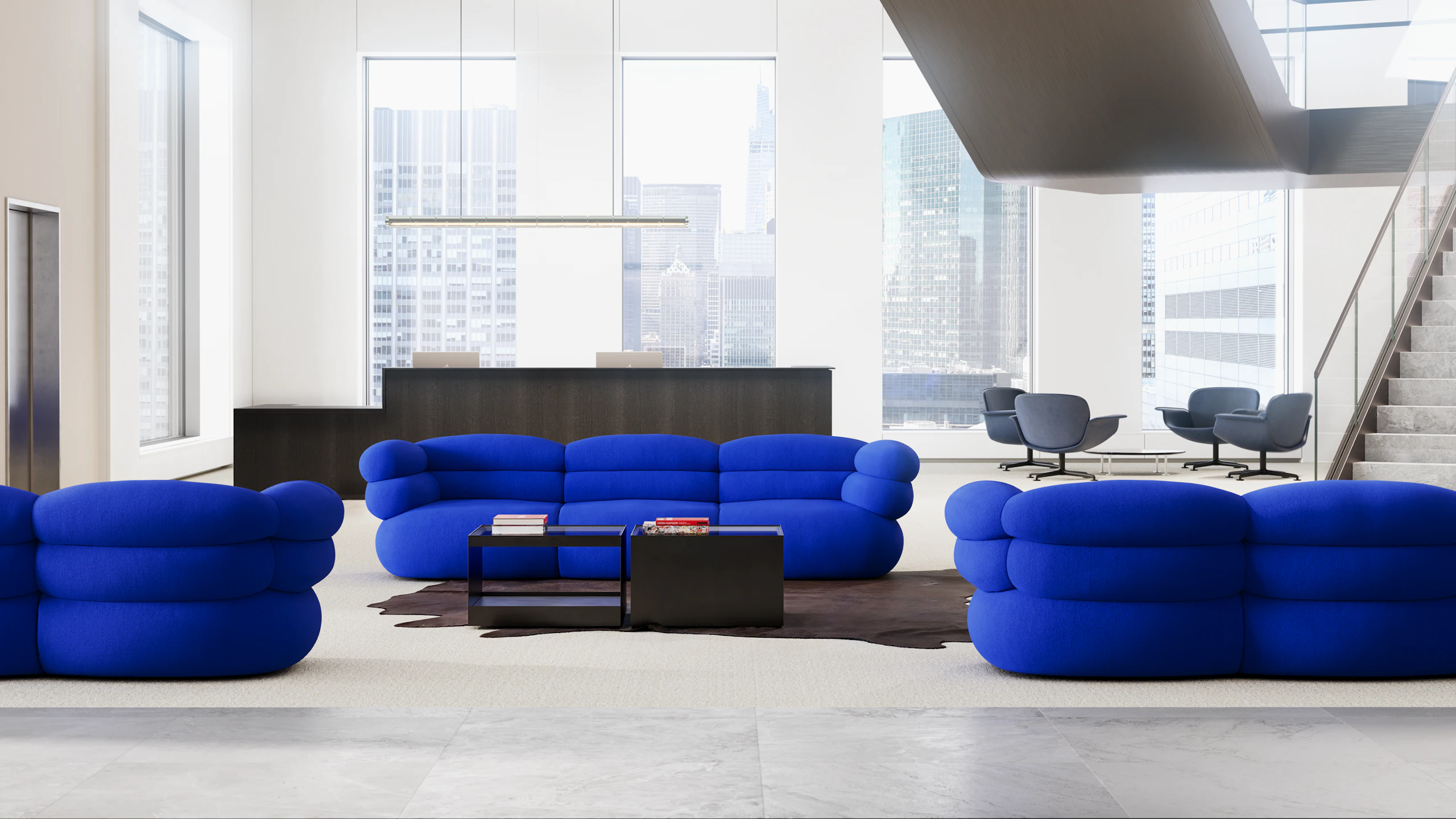 Lobby or reception space with blue Biboni Sofas, black D'Urso Coffee Tables and blue KN01 Lounge Chairs in the background.
