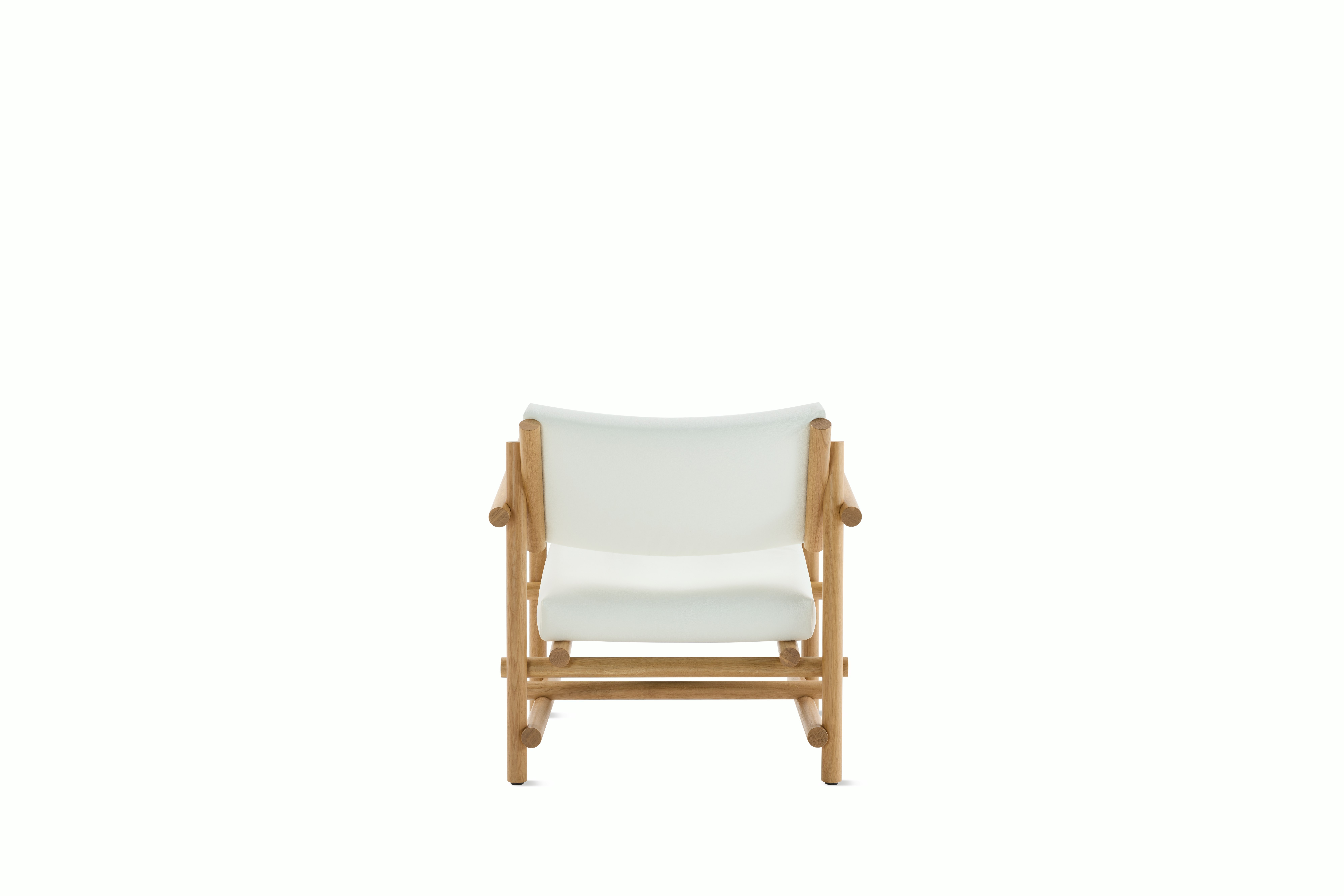 A Muecke Lounge Chair in White White Oak viewed from behind.