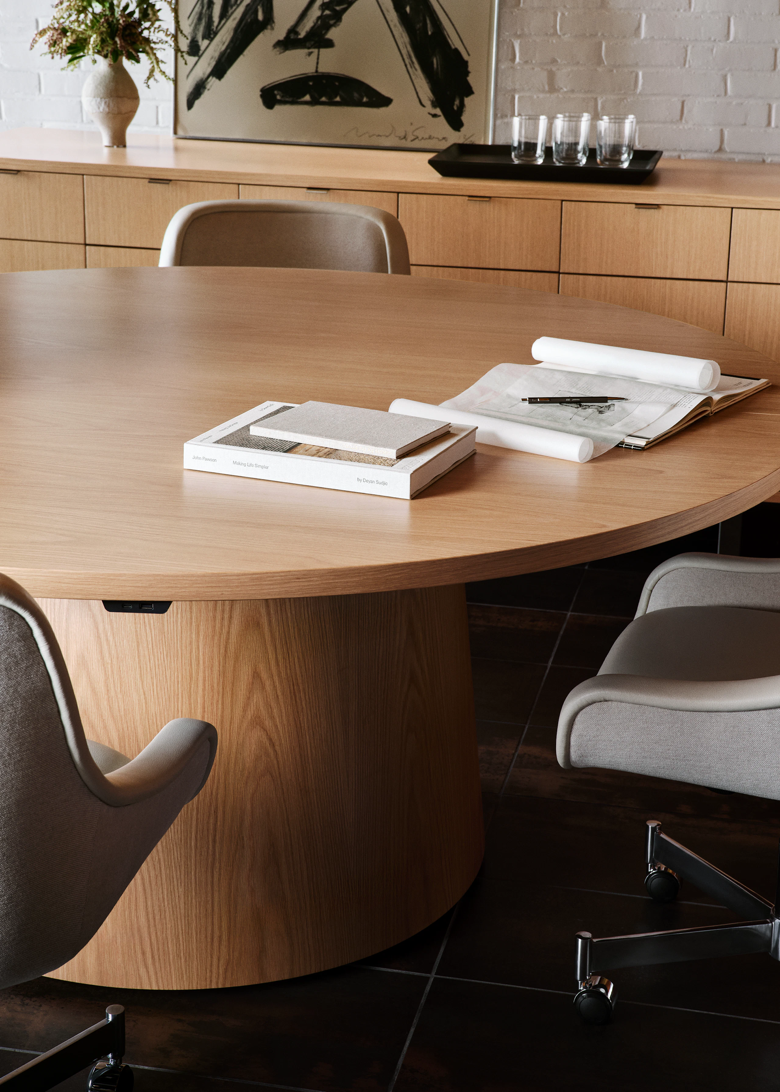 JD Meeting Table in natural flat cut oak shown surrounded by Bumper Chairs in front of a Highline 25 Credenza.
