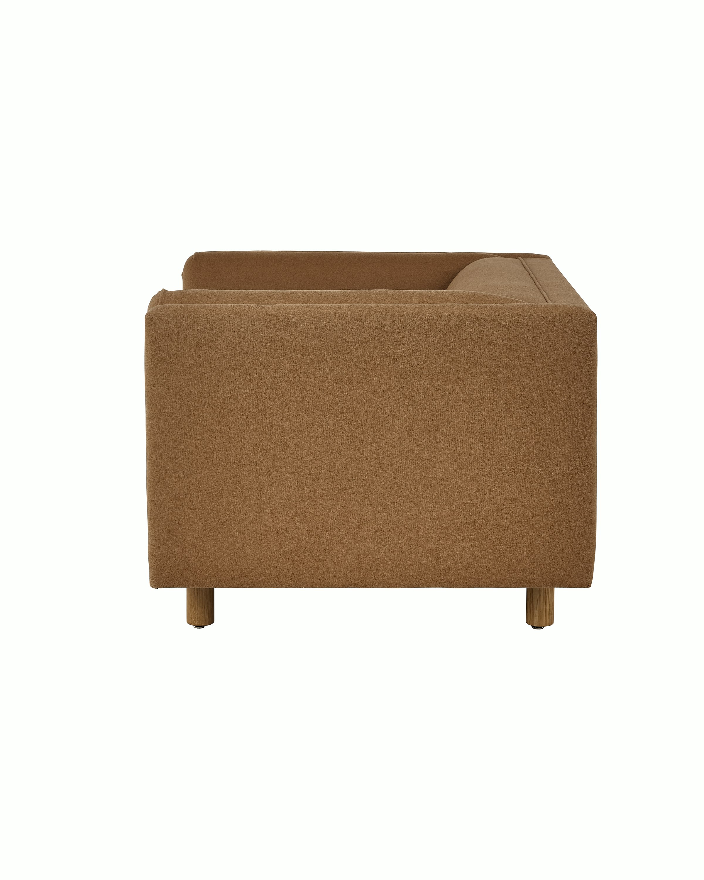 Rolled Arm Club Chair designed by Ward Bennett upholstered in Brushed Camel in Natural with a Natural Oak base, shown in profile on a white sweep.