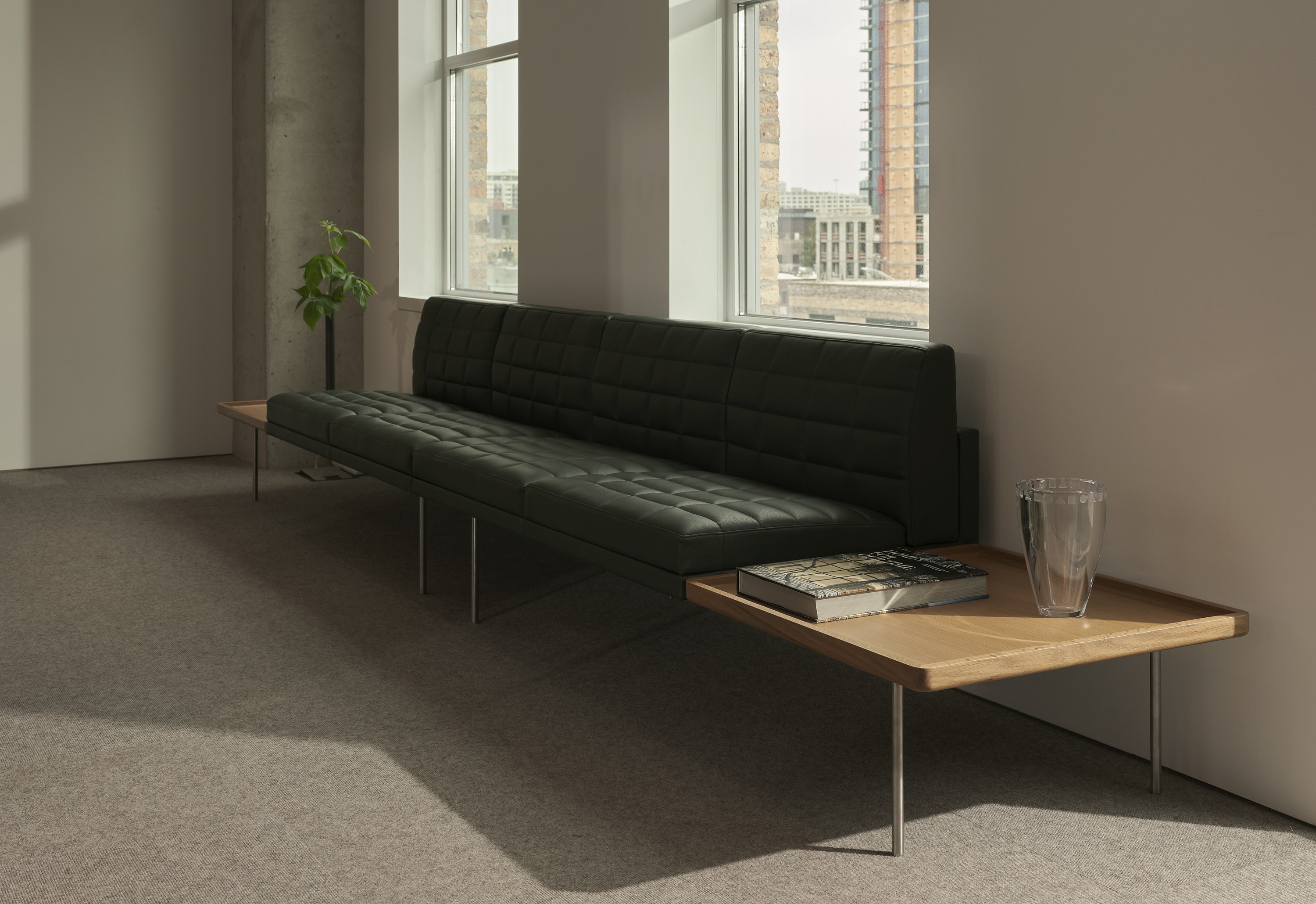 Tuxedo Component Sectional Sofa upholstered with Prone Leather in Vine with integrated tables in Natural Oak on each side, viewed at an angle.