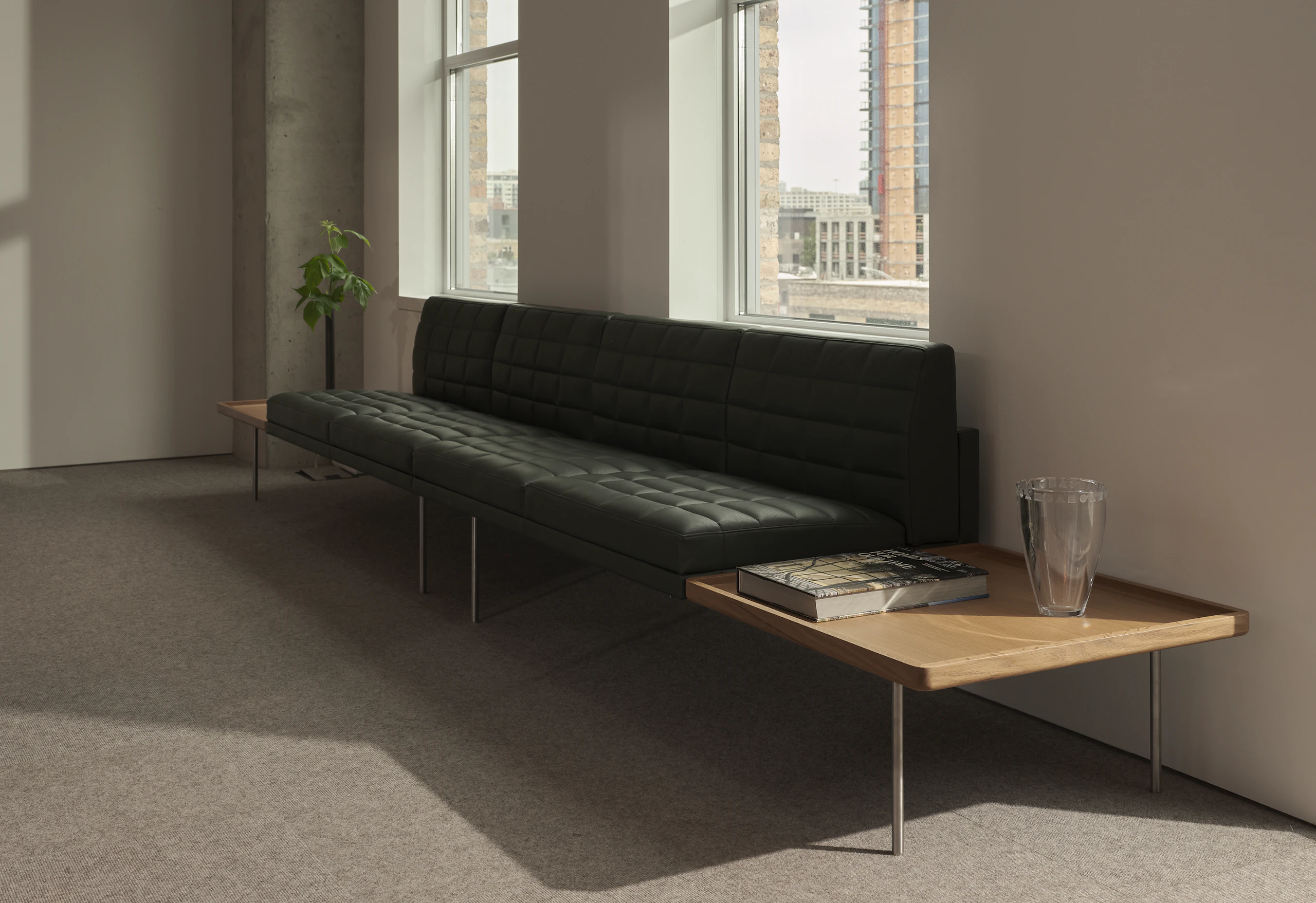 Tuxedo Component Sectional Sofa upholstered with Prone Leather in Vine with integrated tables in Natural Oak on each side, viewed at an angle.