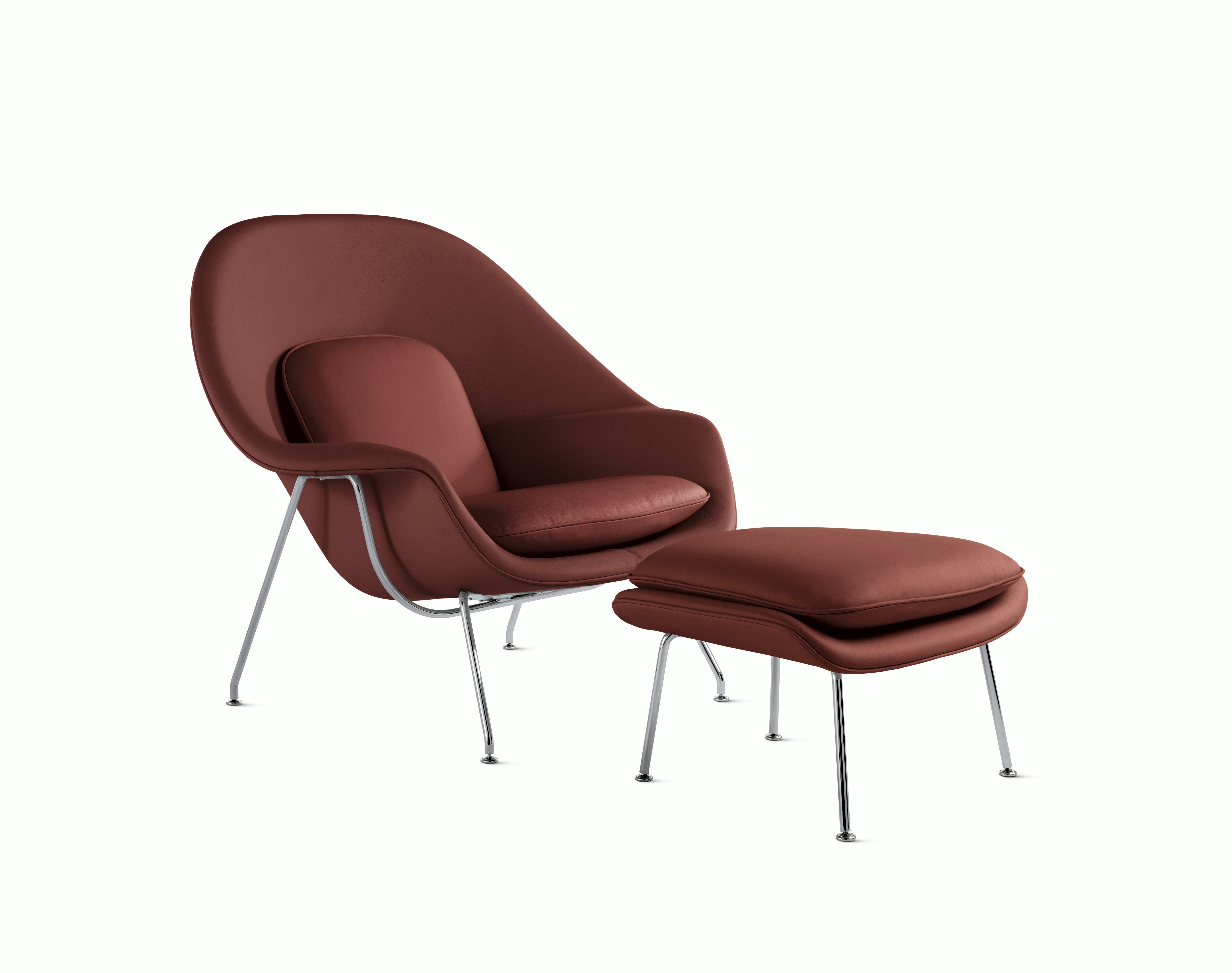 A russet Womb Chair & Ottoman viewed from an angle