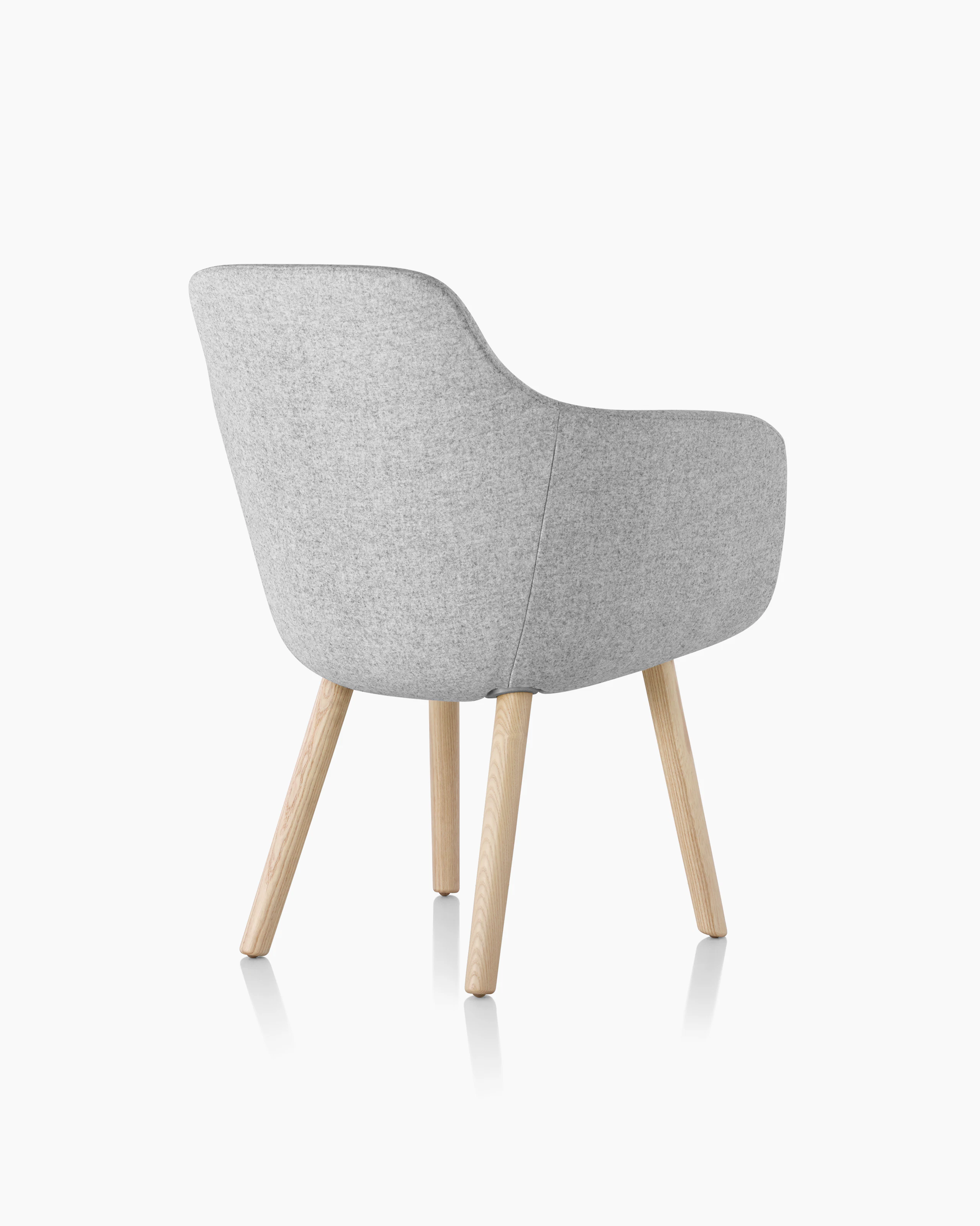 A Saiba Side Chair with light gray upholstery and wood legs in a light finish, viewed from behind at an angle.