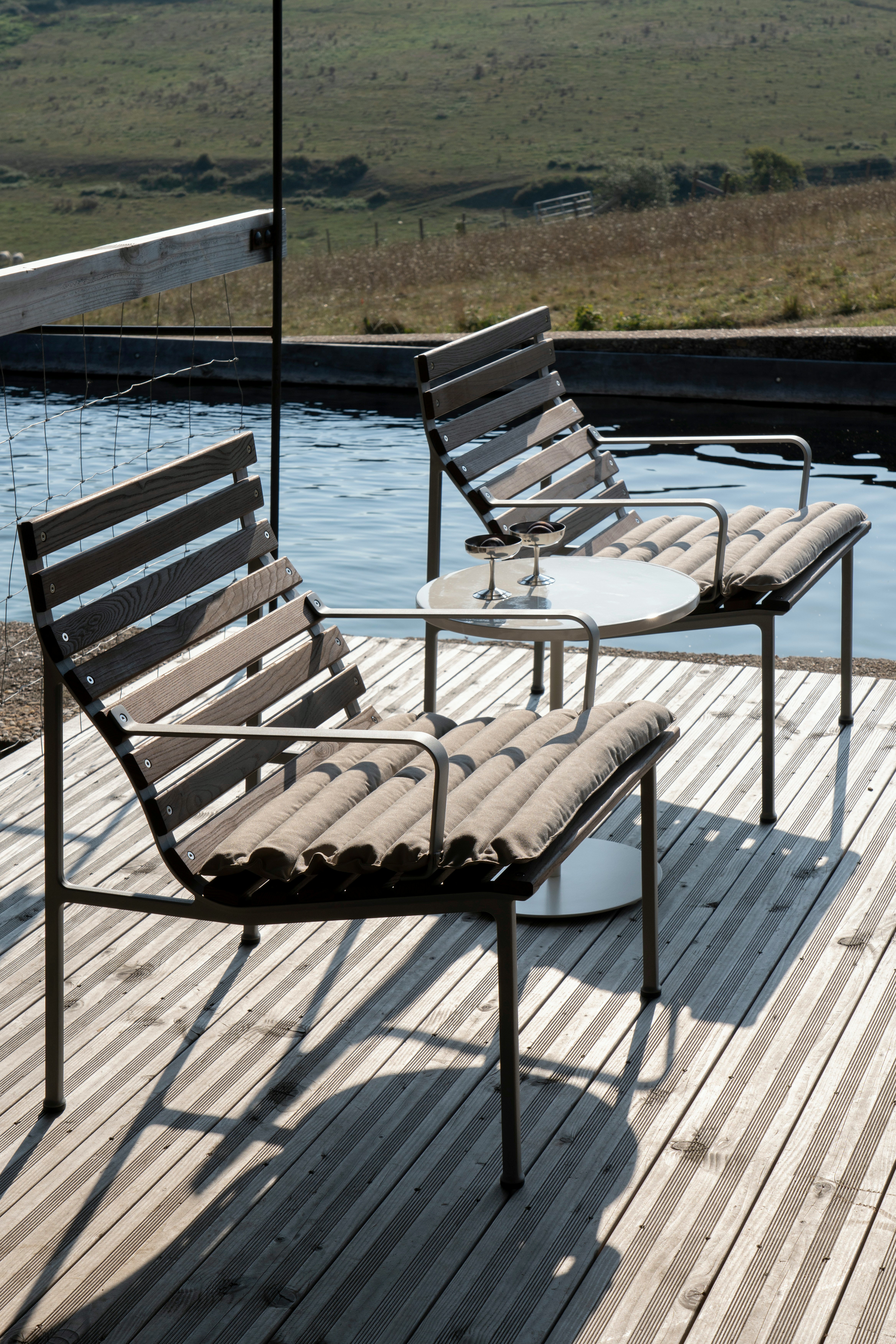 Two Traverse Armchairs with Traverse Seat Cushions at a poolside setting