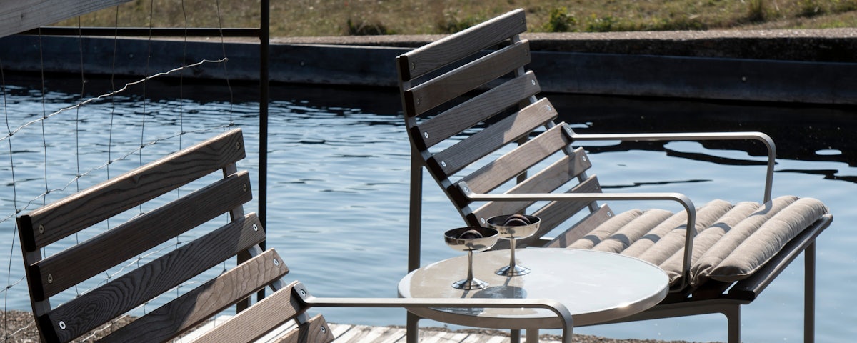 Two Traverse Armchairs with Traverse Seat Cushions at a poolside setting