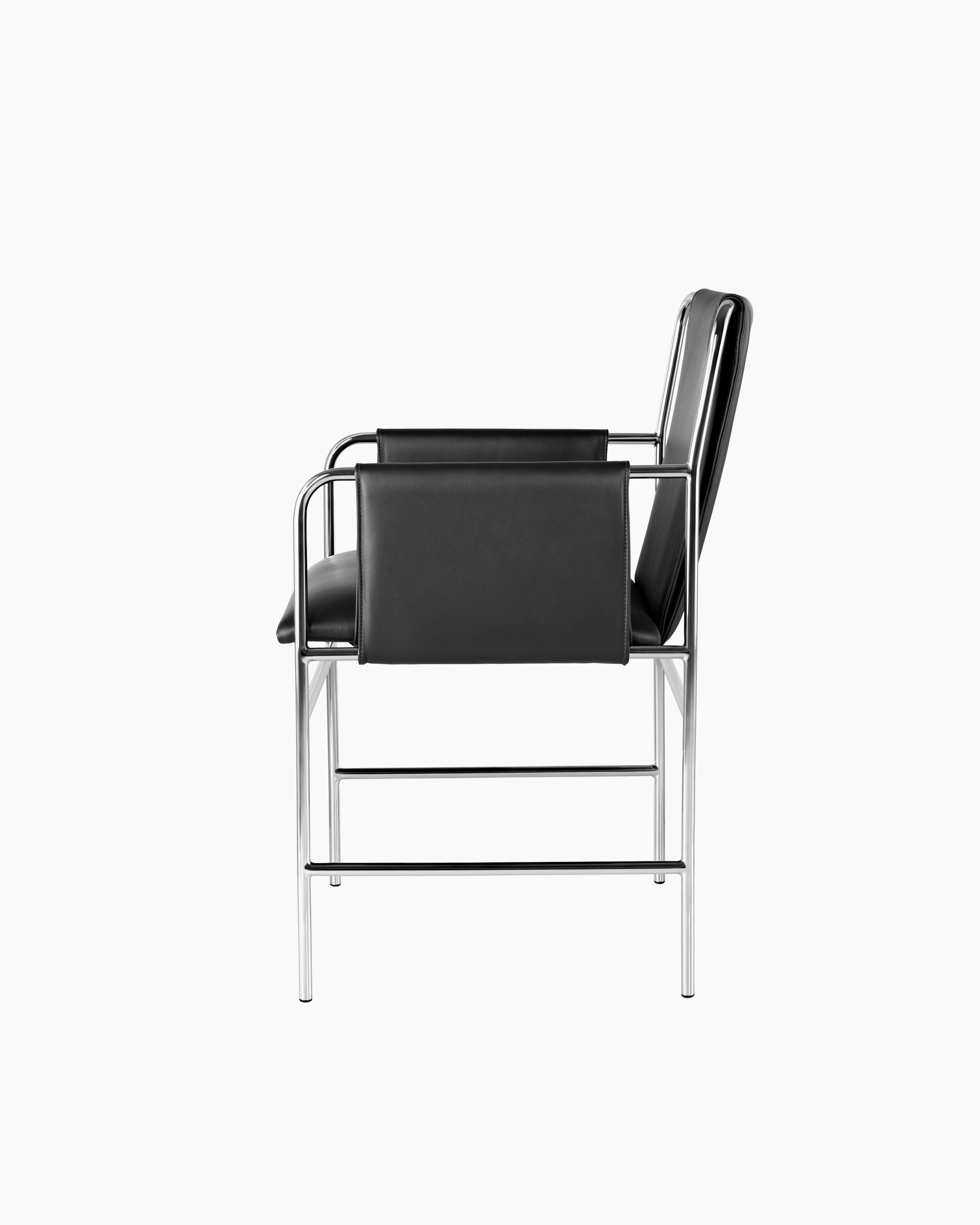 Side view of an Envelope side chair with black leather upholstery and a tubular steel frame.