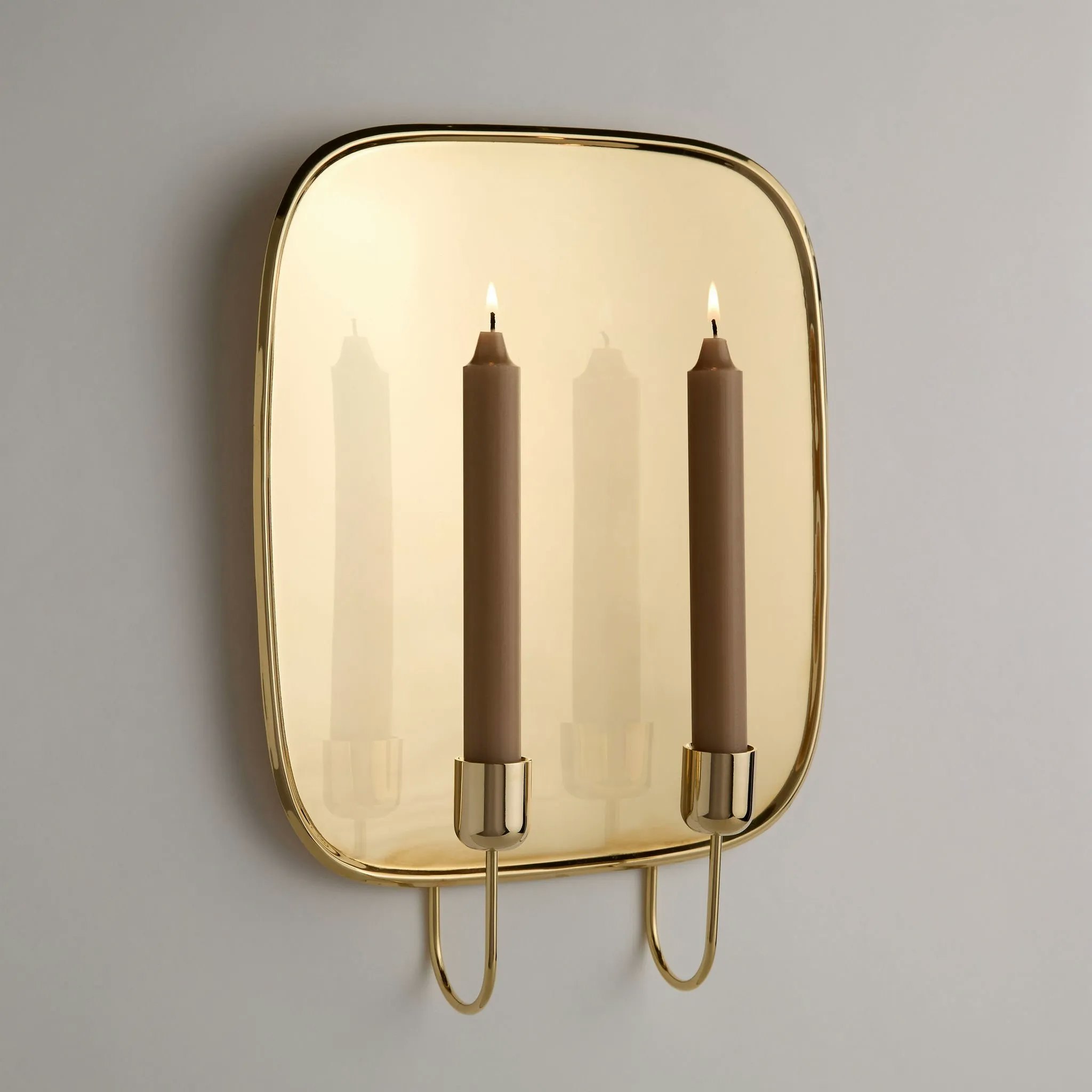 A detail Uma Brass Wall Sconce Candleholder in Brass.