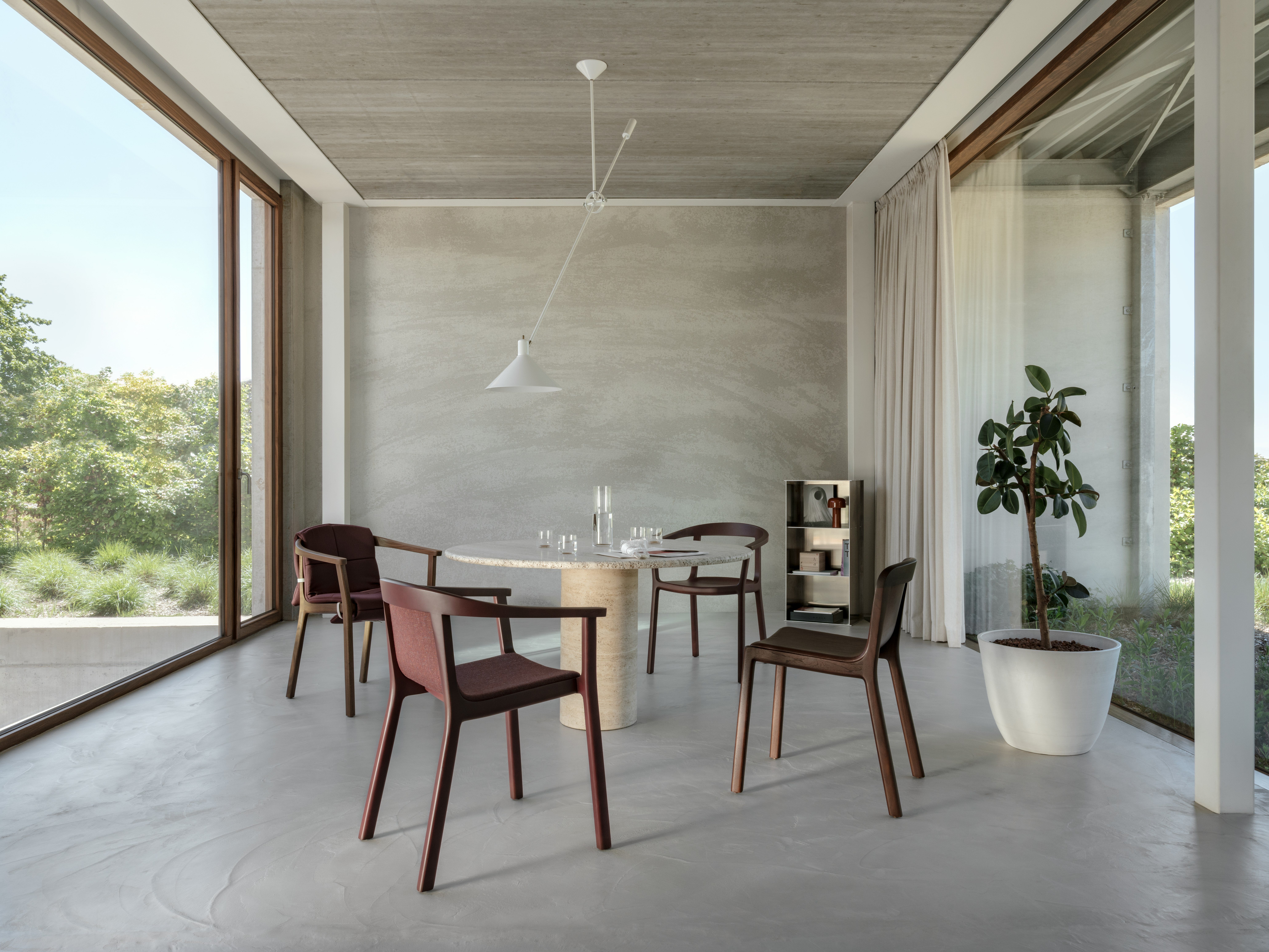 Lijn Arm Chairs and Side Chairs designed by Carole Baijings for Geiger in Red Clay and Persian Walnut frames shown in a residential setting.