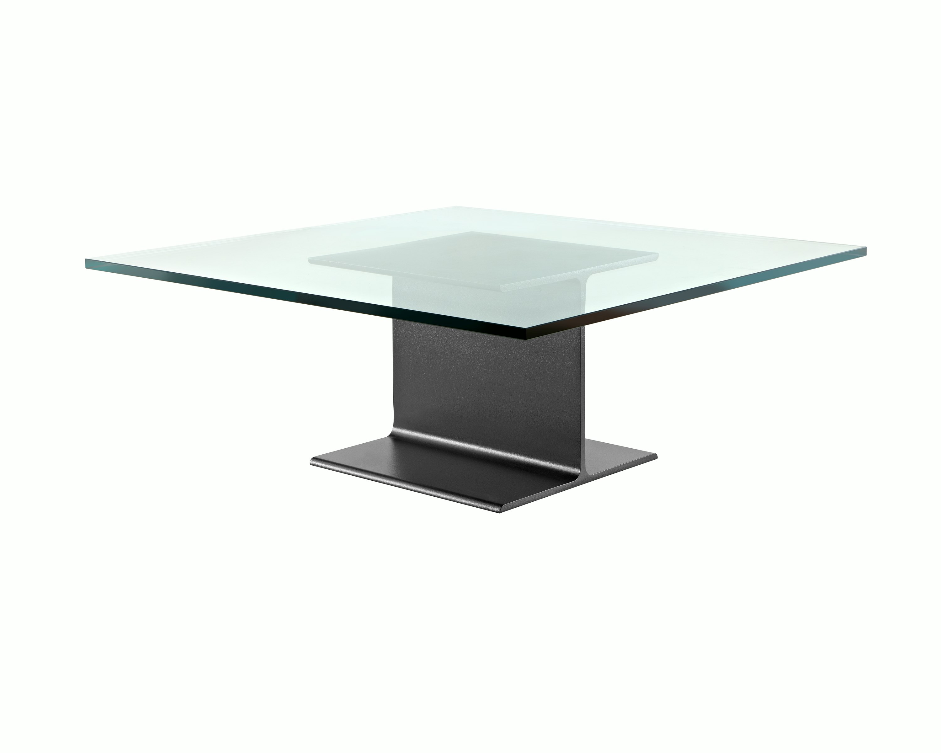 Partial angled view of a square I Beam coffee table with a glass top and black cast-aluminum pedestal.