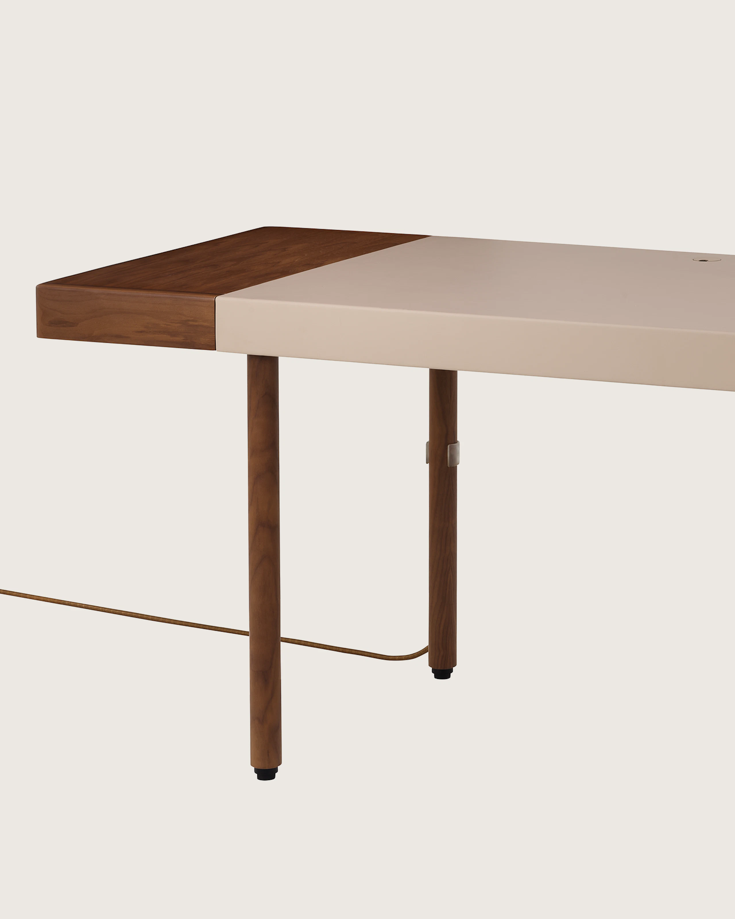 New Canaan Leatherwrap Sit-to-Stand Desk in Walnut and Champagne Leather, one drawer on left side with cord, angled view.