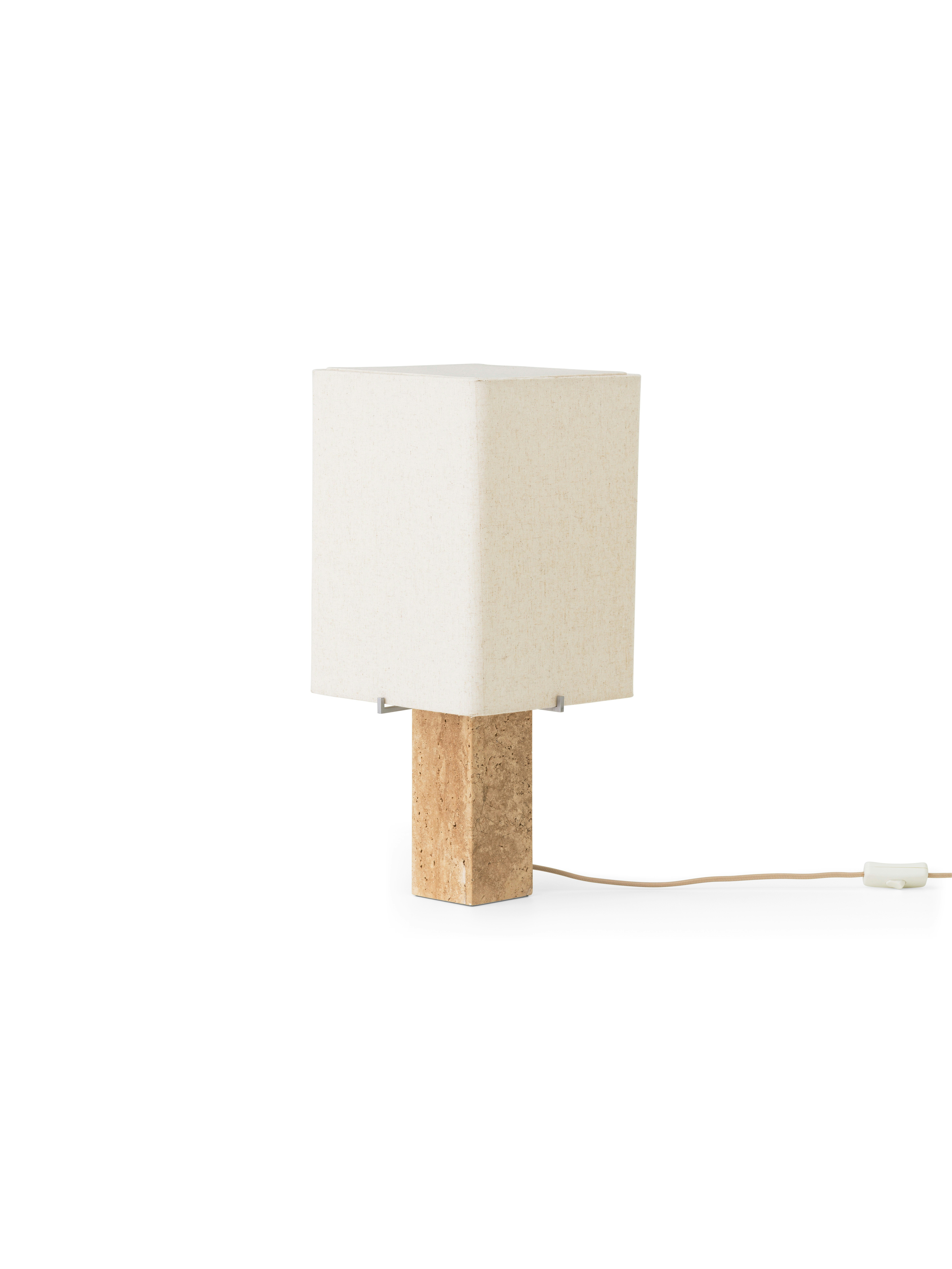 A Nonna Travertine Table Lamp in Tall viewed from an angle.