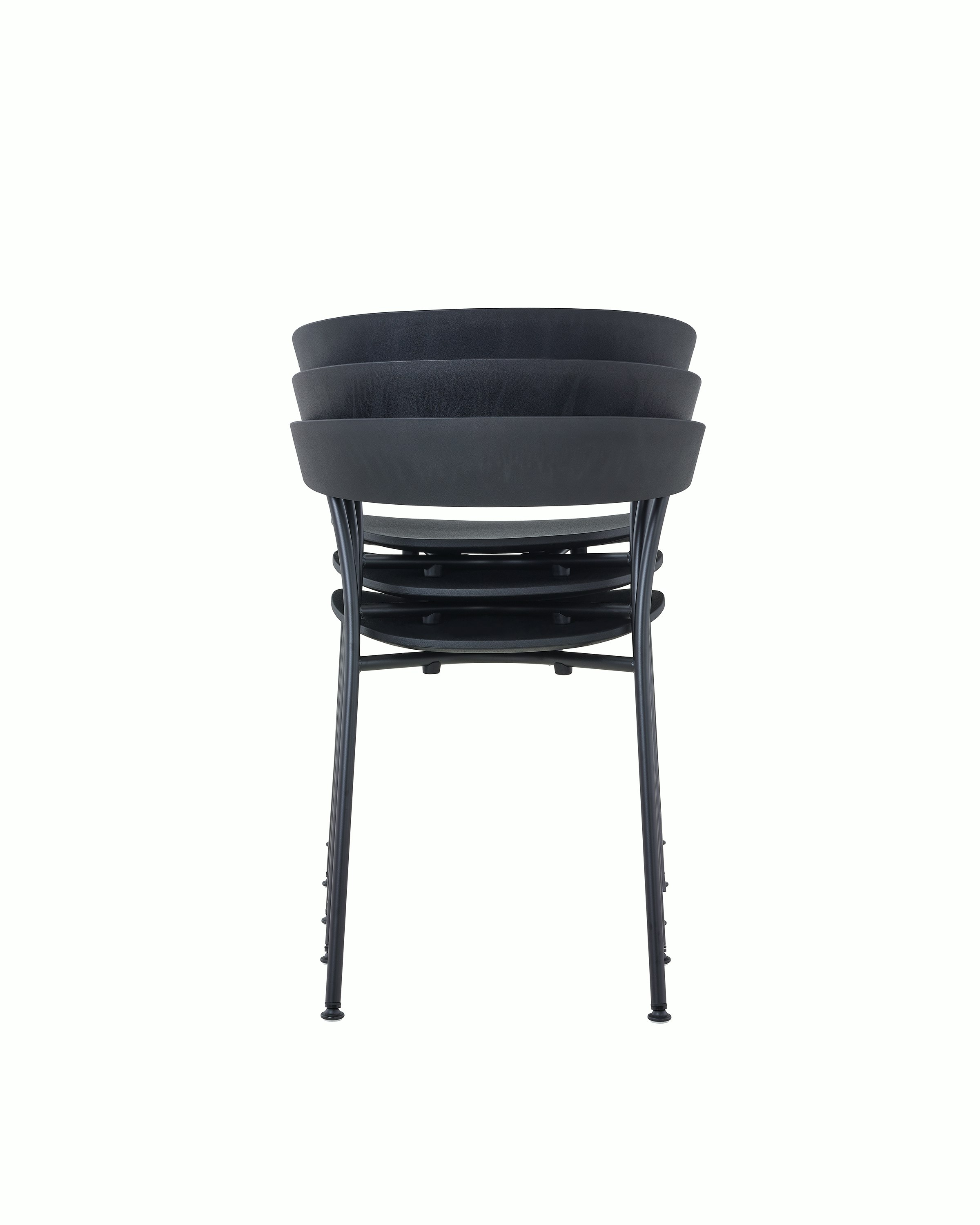 A stack of three black Leeway Chairs, viewed from the back.